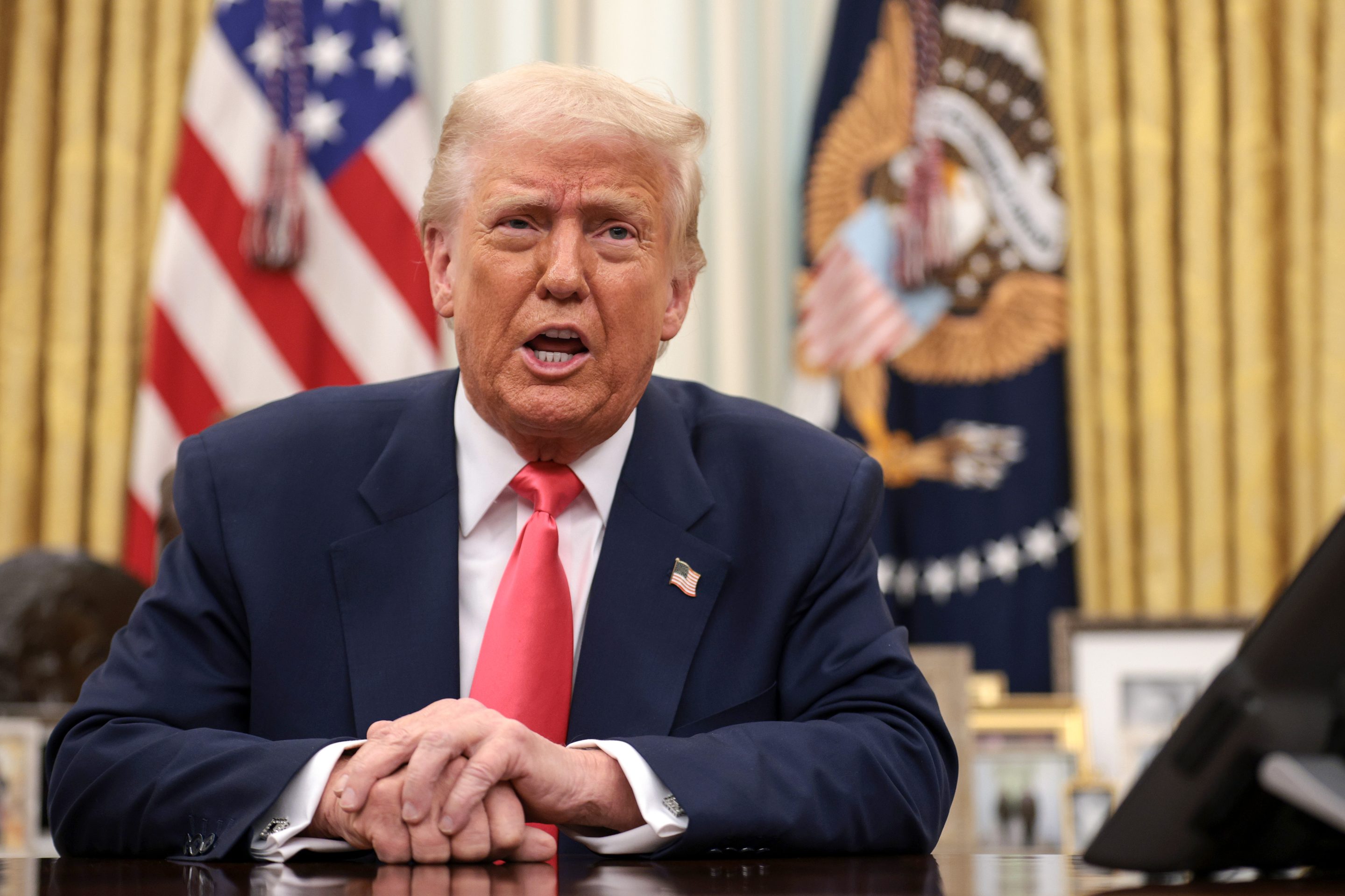 Trump speaks from the Resolute Desk in the Oval Office