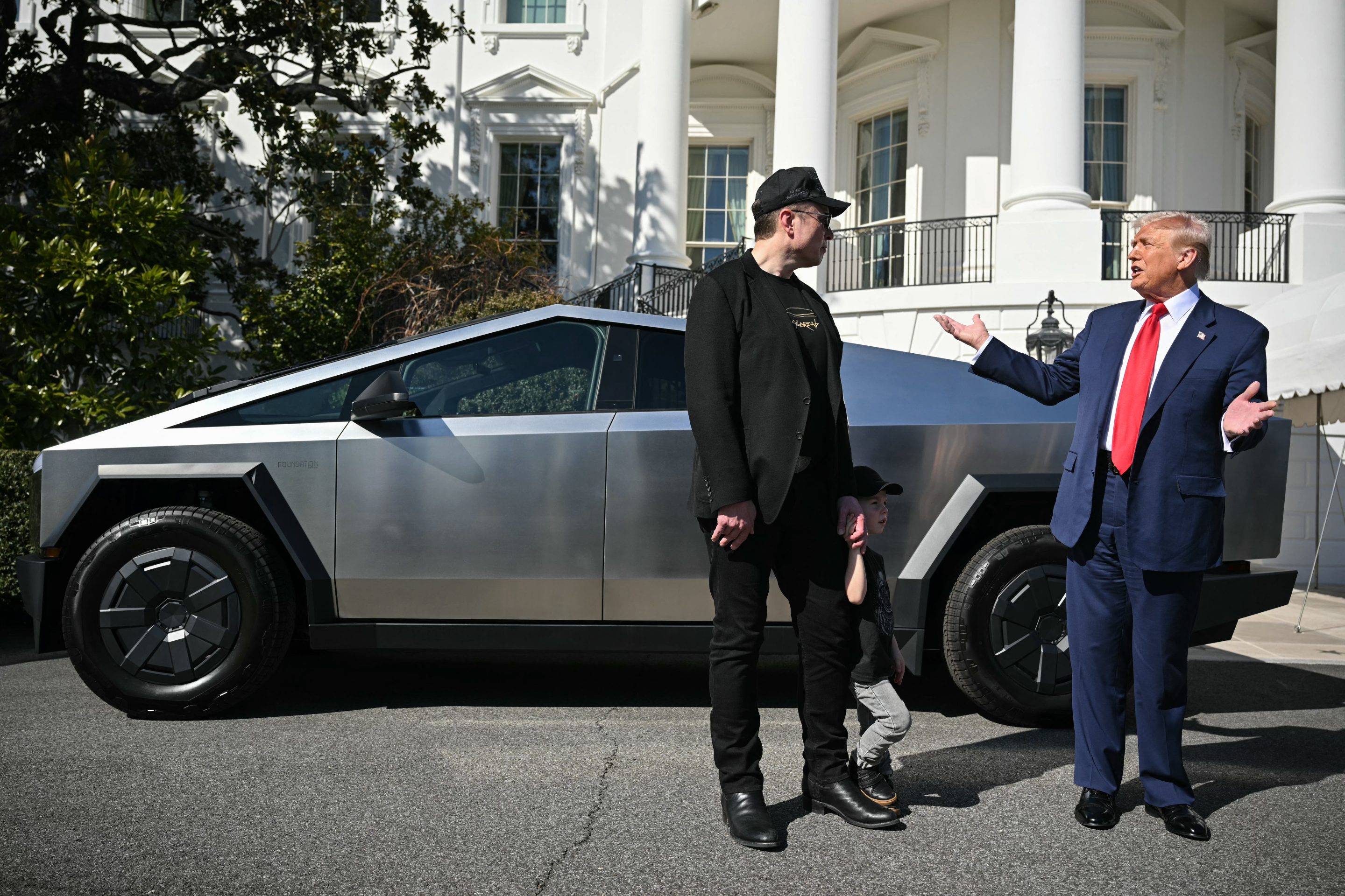 U.S. President Donald Trump and Tesla CEO Elon Musk stand next to a Tesla Cybertruck on the South Portico of the White House on March 11, 2025 in Washington, D.C. (Photo by Mandel Ngan/AFP/Getty Images)