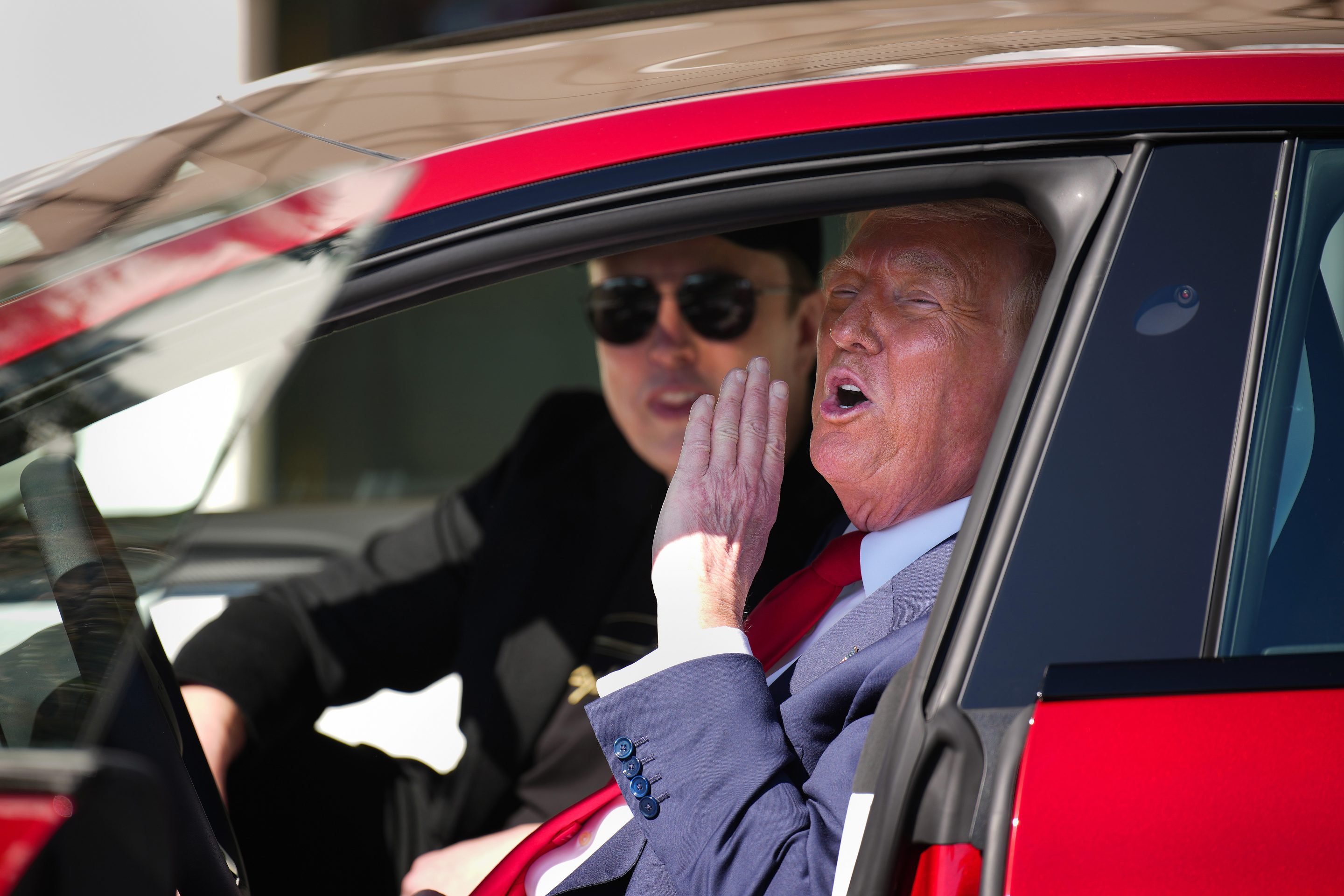 U.S. President Donald Trump and White House Senior Advisor, Tesla and SpaceX CEO Elon Musk sit in a Tesla Model S