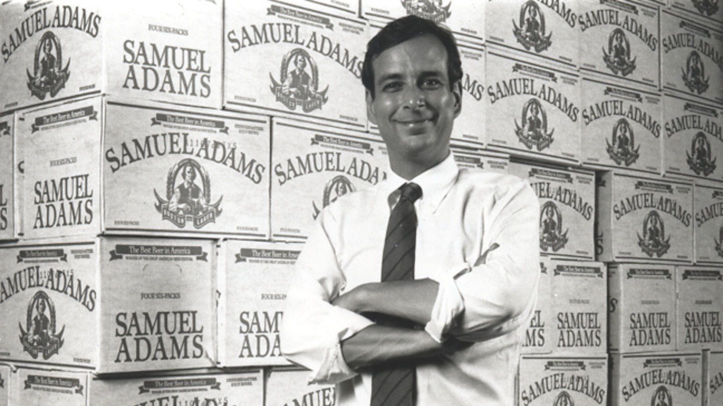 Founder Jim Koch poses by cases of Samuel Adams.