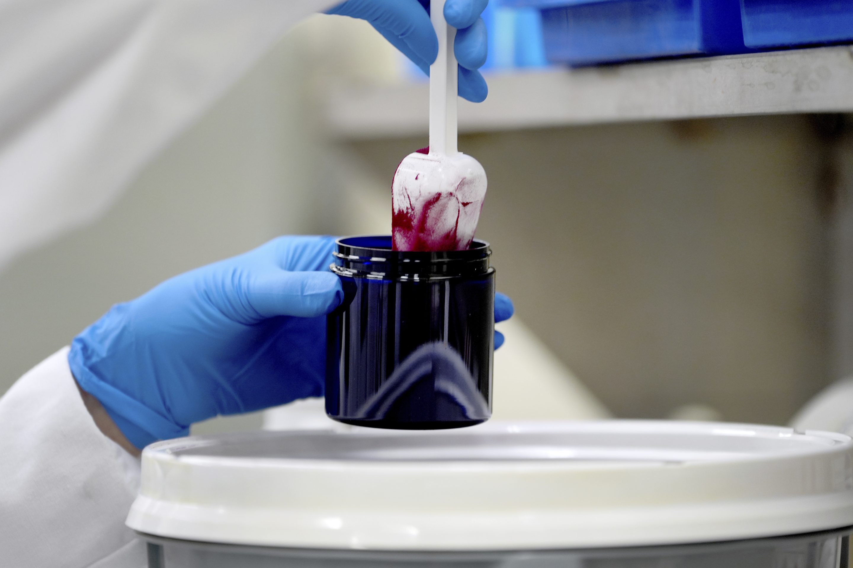 Technician Heather Browning packages a color sample made of beet powder for a customer at Sensient Technologies, a color additive manufacturing company, in St. Louis., on April 2, 2025.