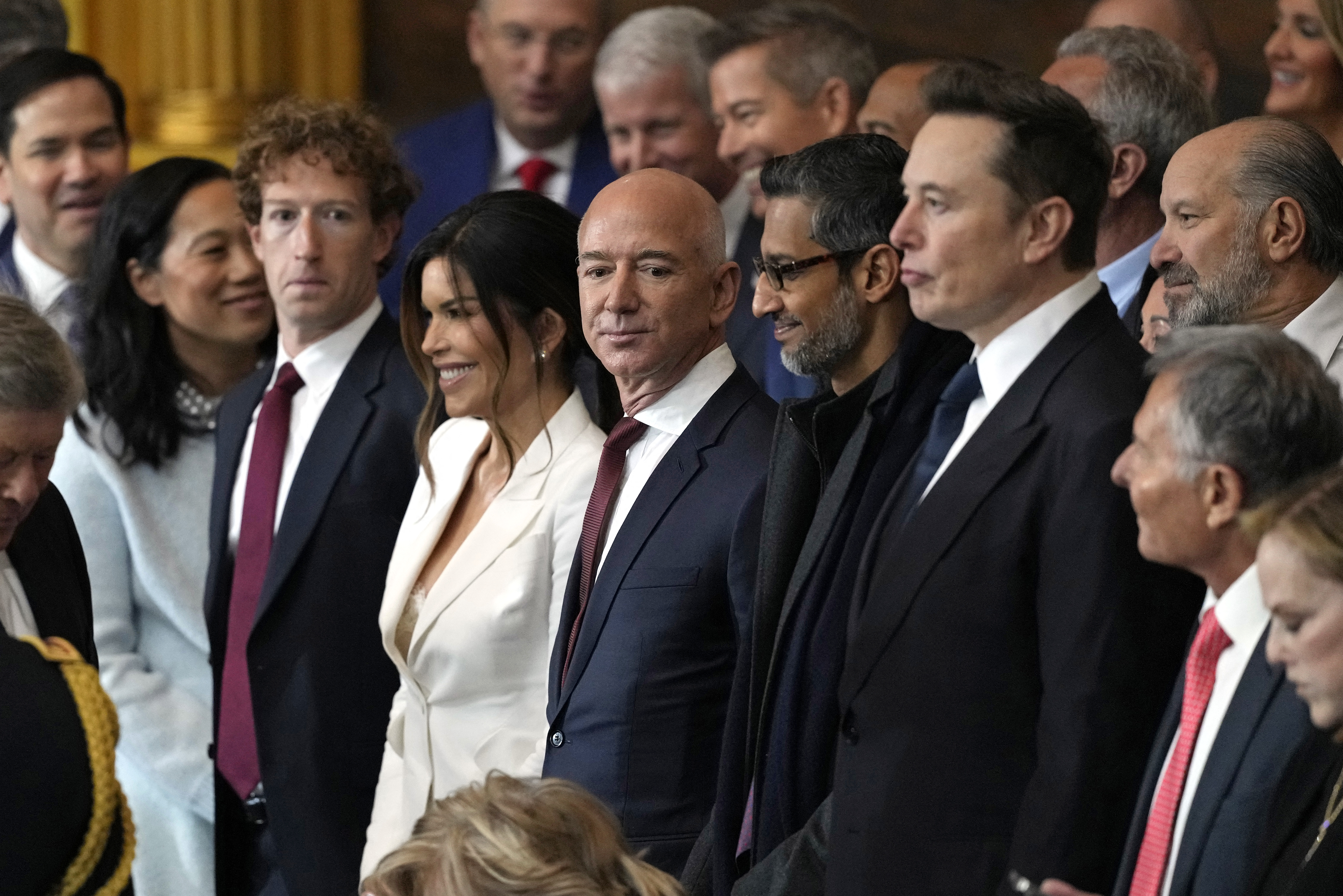 Mark Zuckerberg, Lauren Sanchez, Jeff Bezos, Sundar Pichai and Elon Musk standing together at Trump's inauguration
