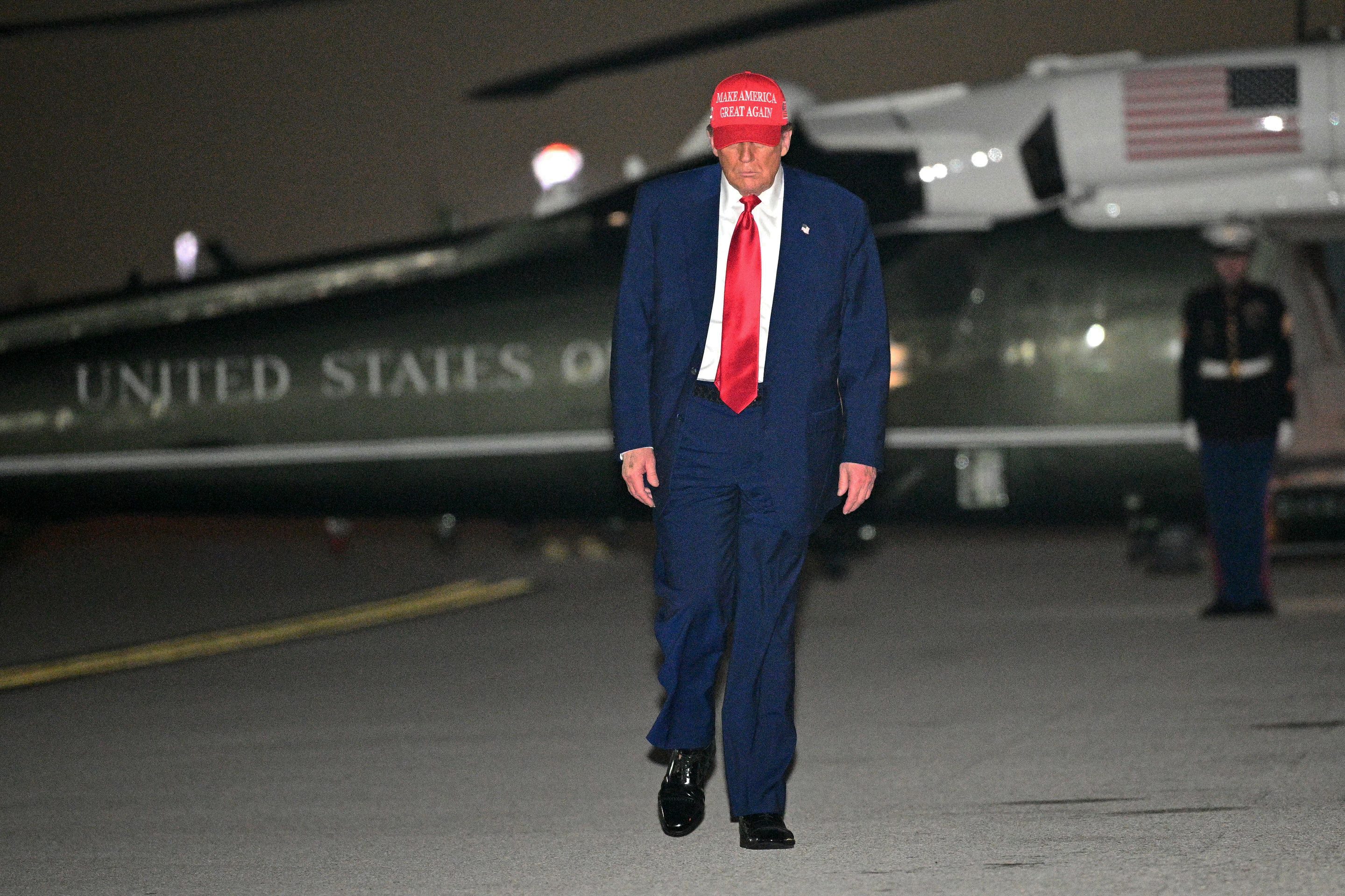 President Donald Trump steps off Marine One and walks to board Air Force One before departing Miami International Airport, in Miami, Florida on Thursday.