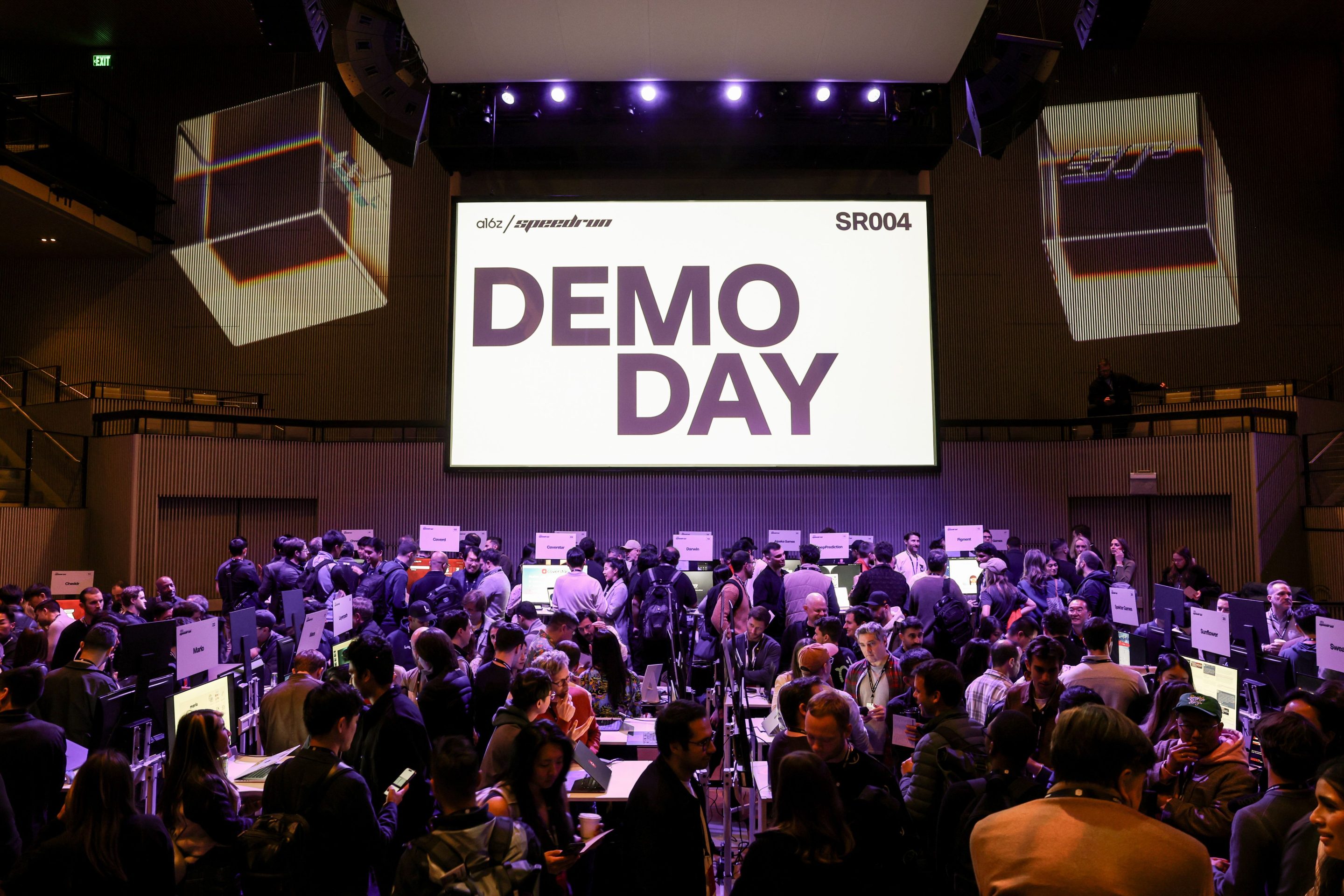 screen with words DEMO DAY and crowd gathered below