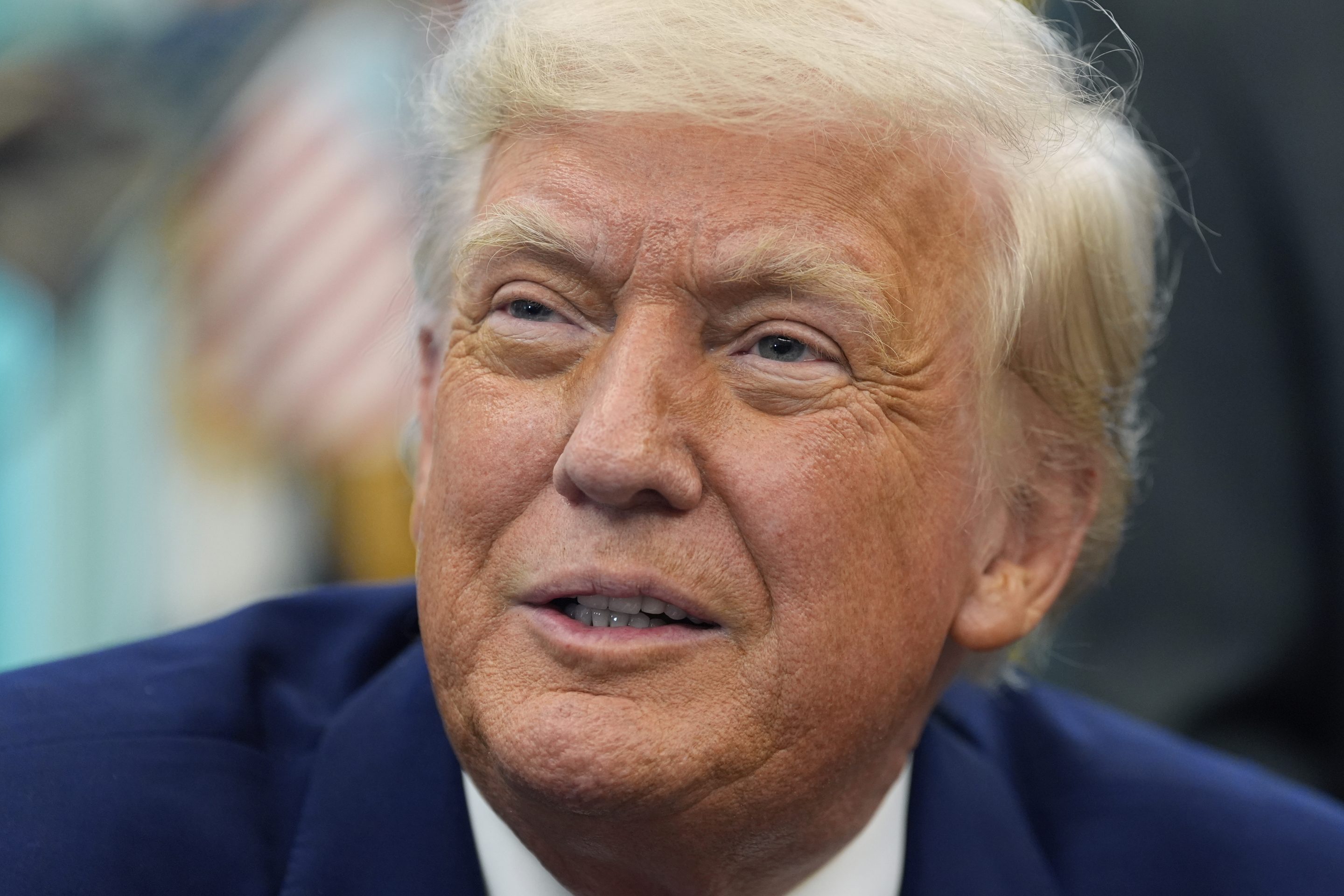 President Donald Trump speaks with reporters as he signs an executive order in the Oval Office of the White House, on May 9, 2025, in Washington.