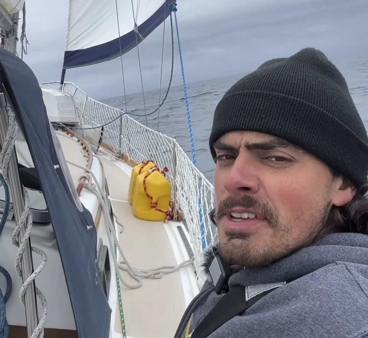 Oliver Widger talks to the camera somewhere in the Pacific Ocean as he and his cat, Phoenix, sail from Oregon to Hawaii. 