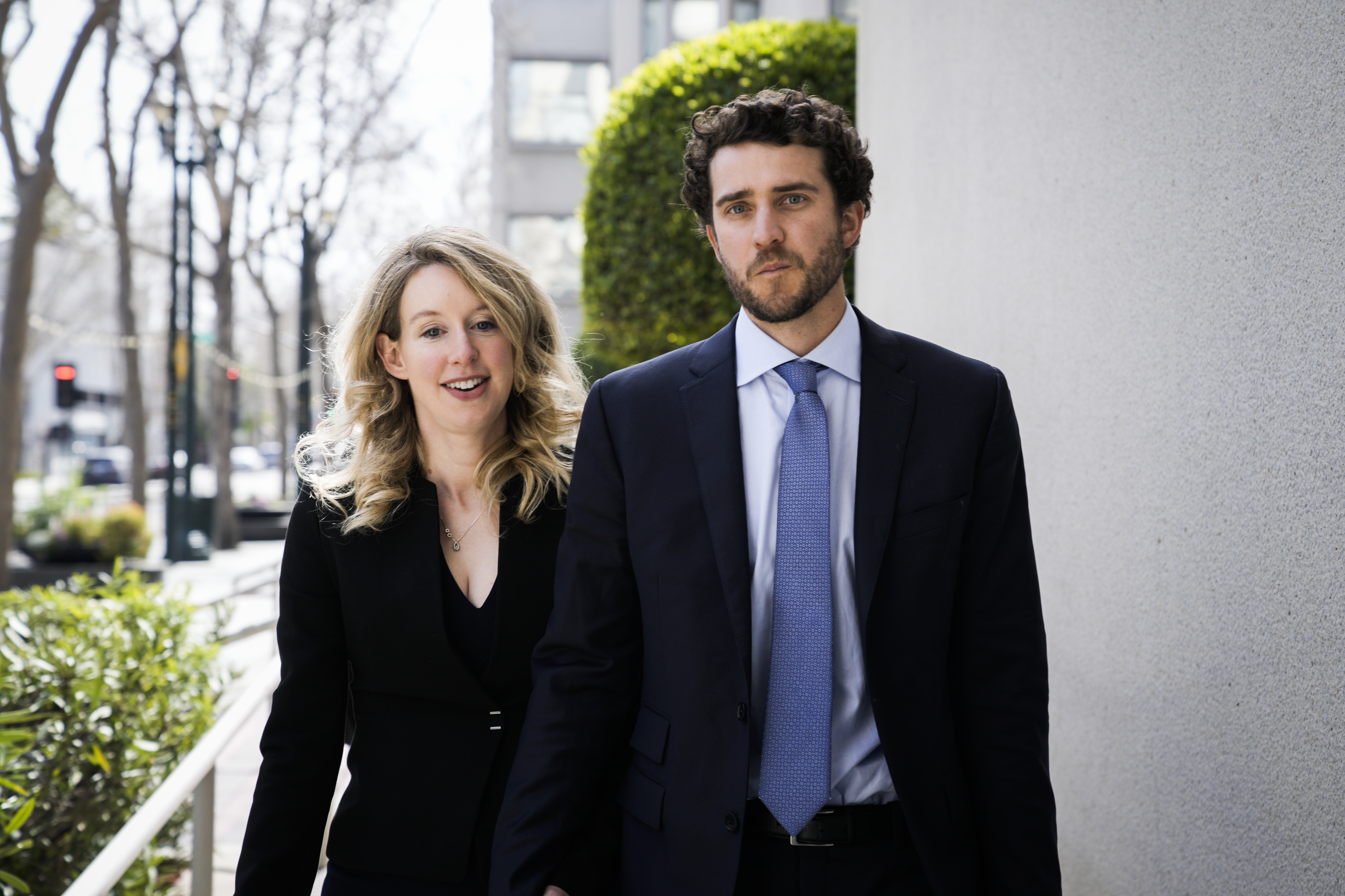 Elizabeth Holmes walking hand in hand with her boyfriend Billy Evans.
