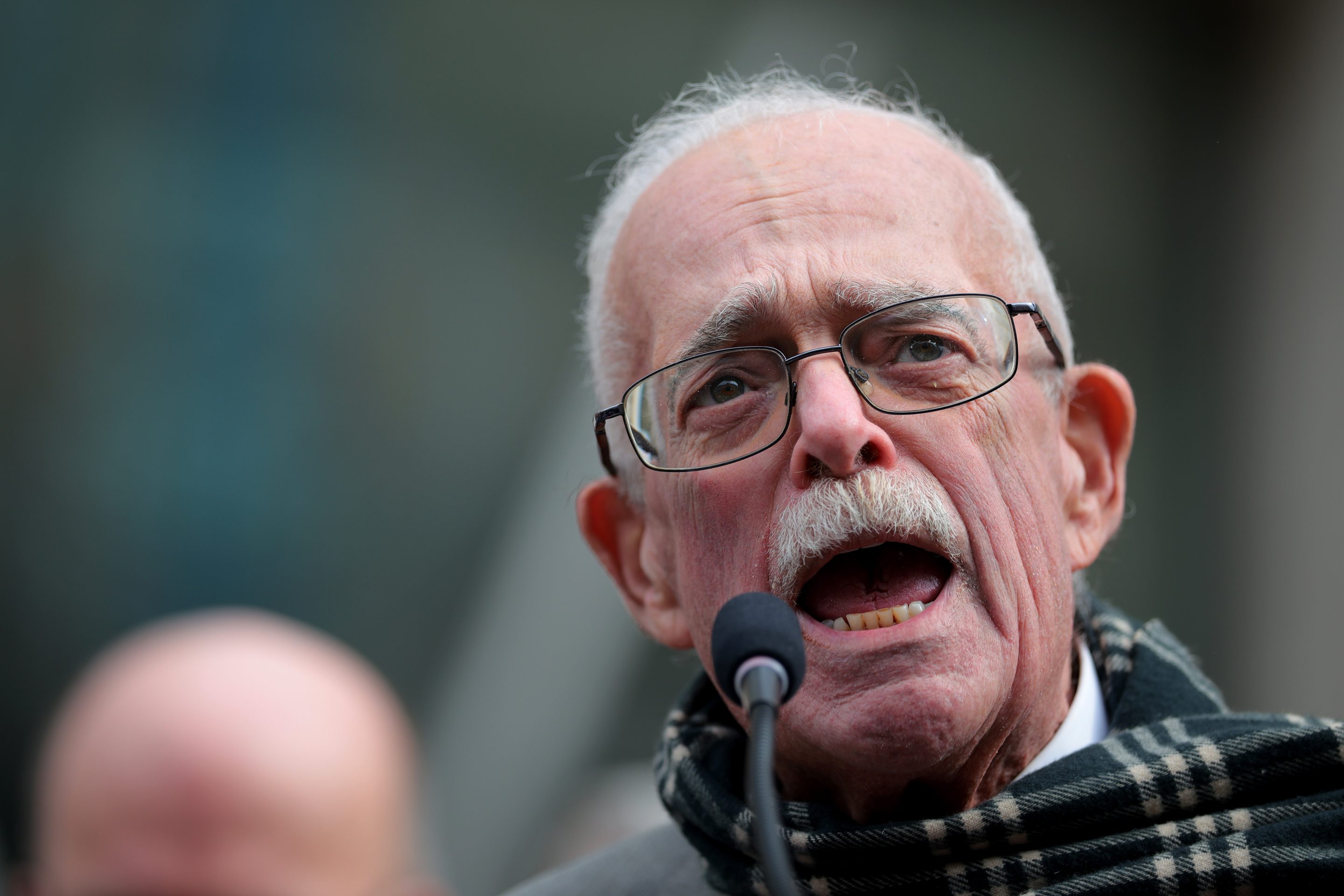 Gerry Connolly shouts into a microphone at a rally against Elon Musk and DOGE