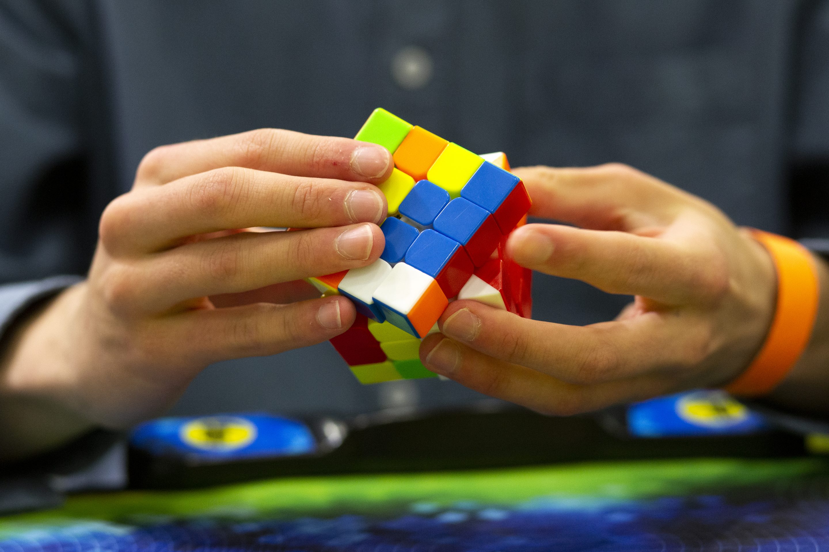 hands holding a rubik's cube