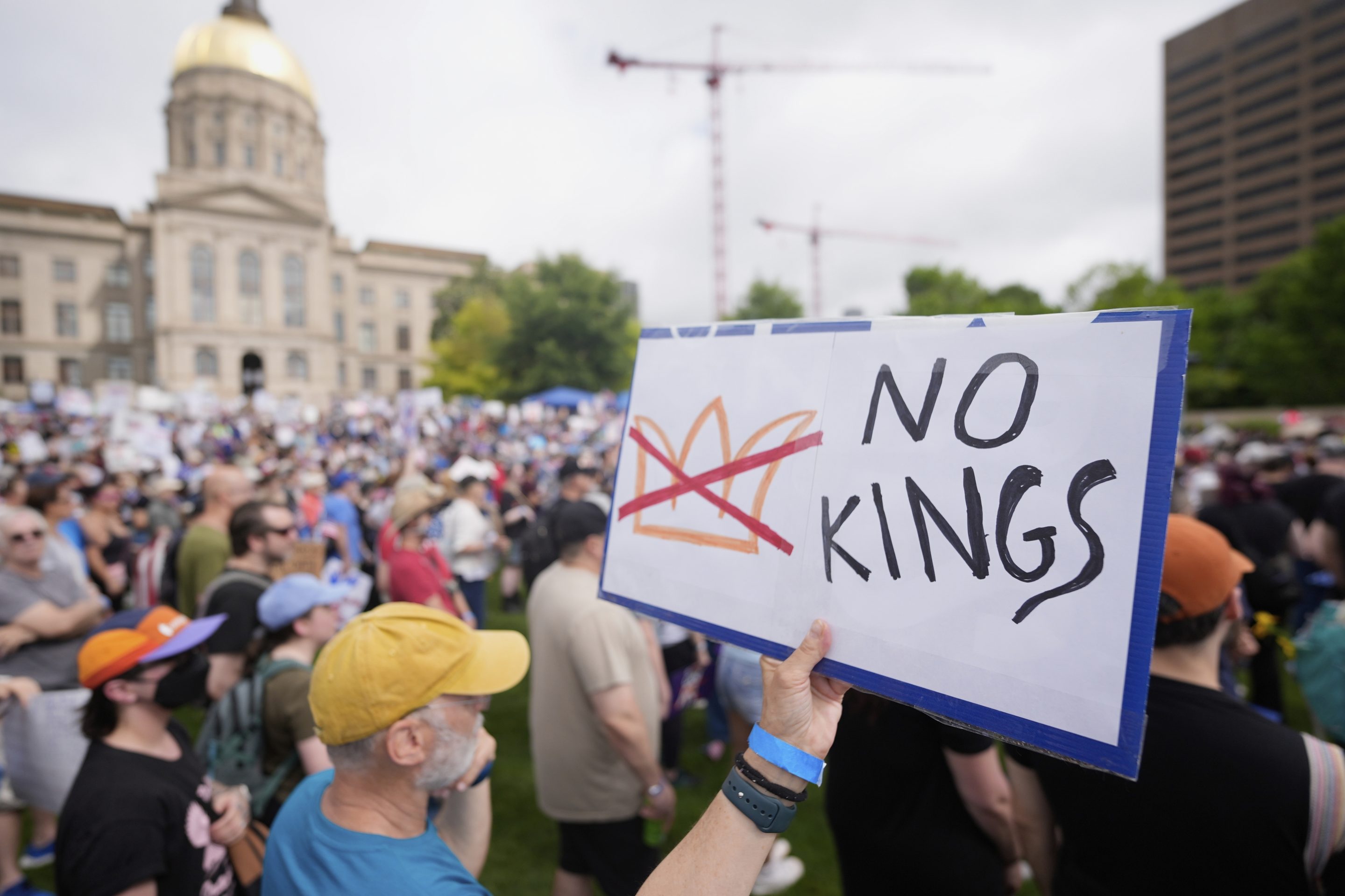 A demonstrator holds a sign during a "No Kings" protest in Atlanta on Saturday.