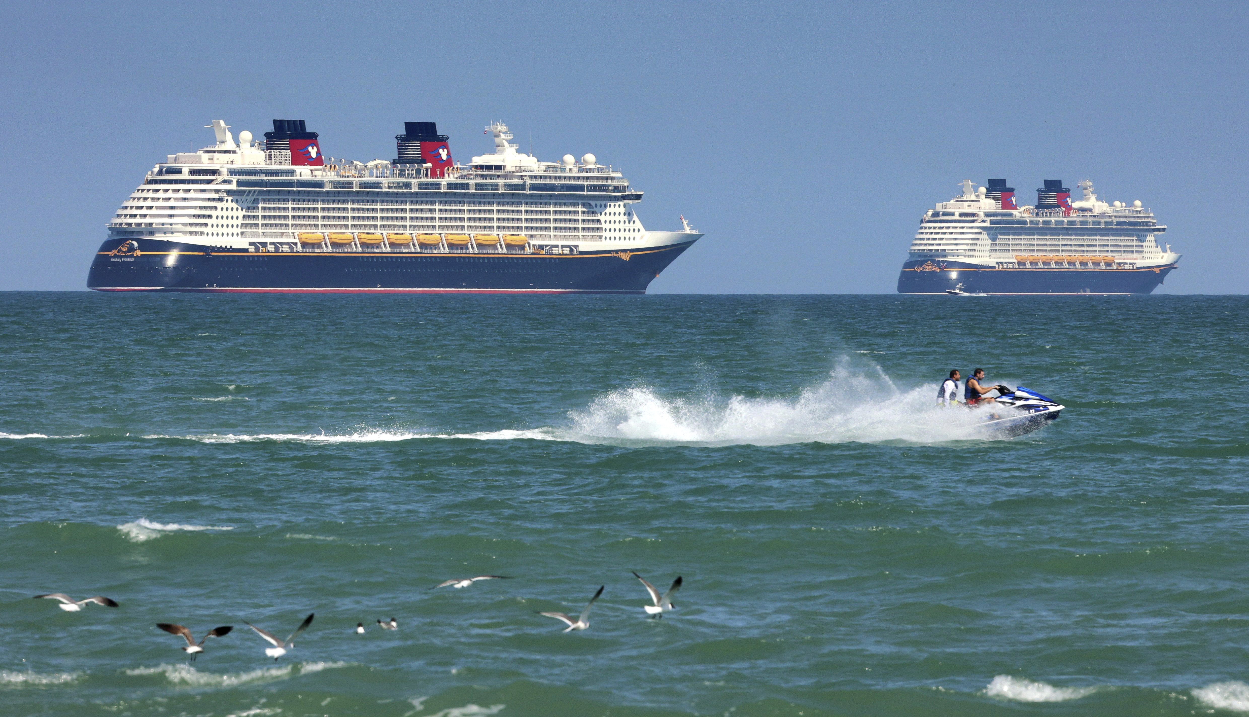 Crew members from a Disney cruise ship saved a girl who fell overboard and her father who jumped in after her.