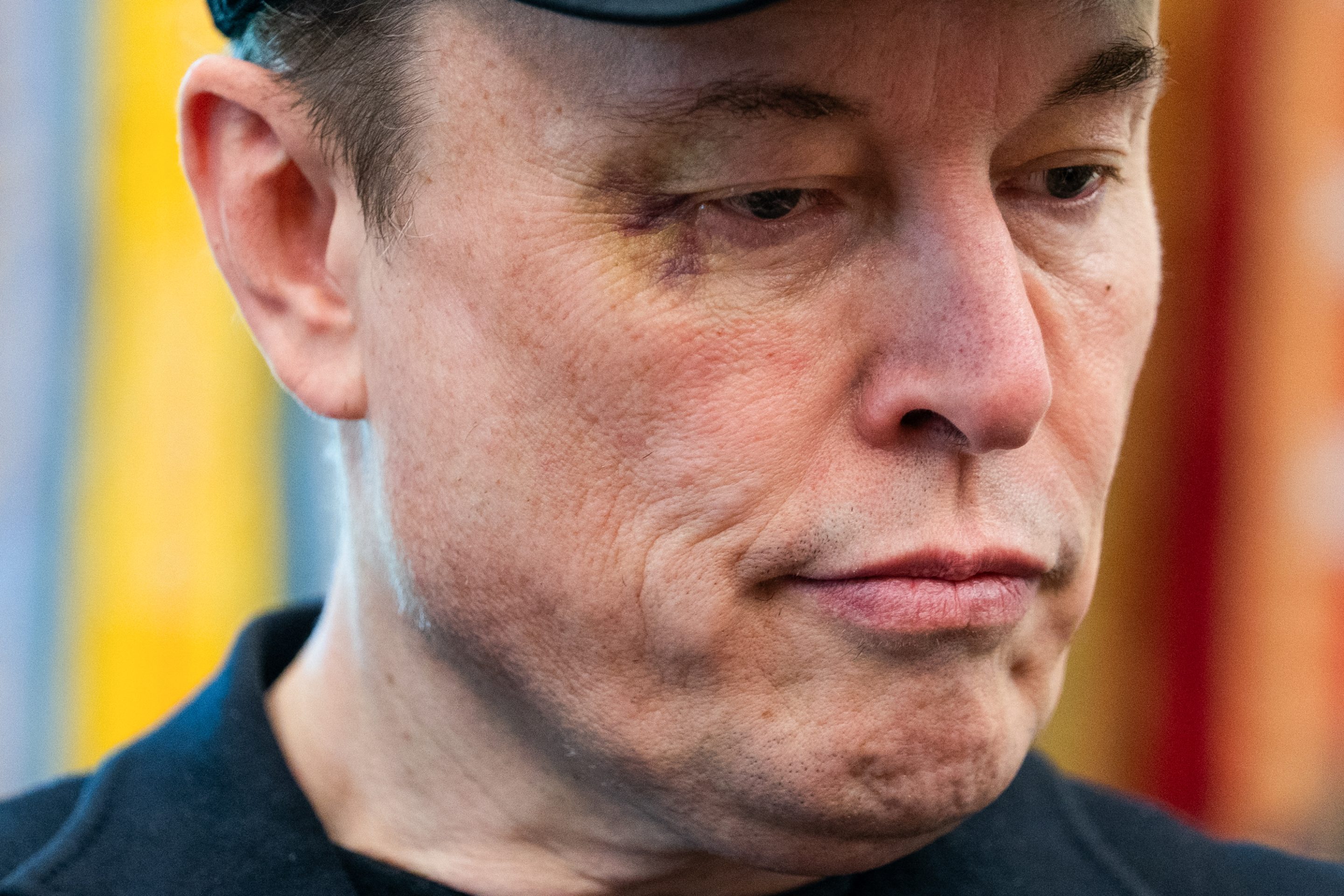 Elon Musk looks down