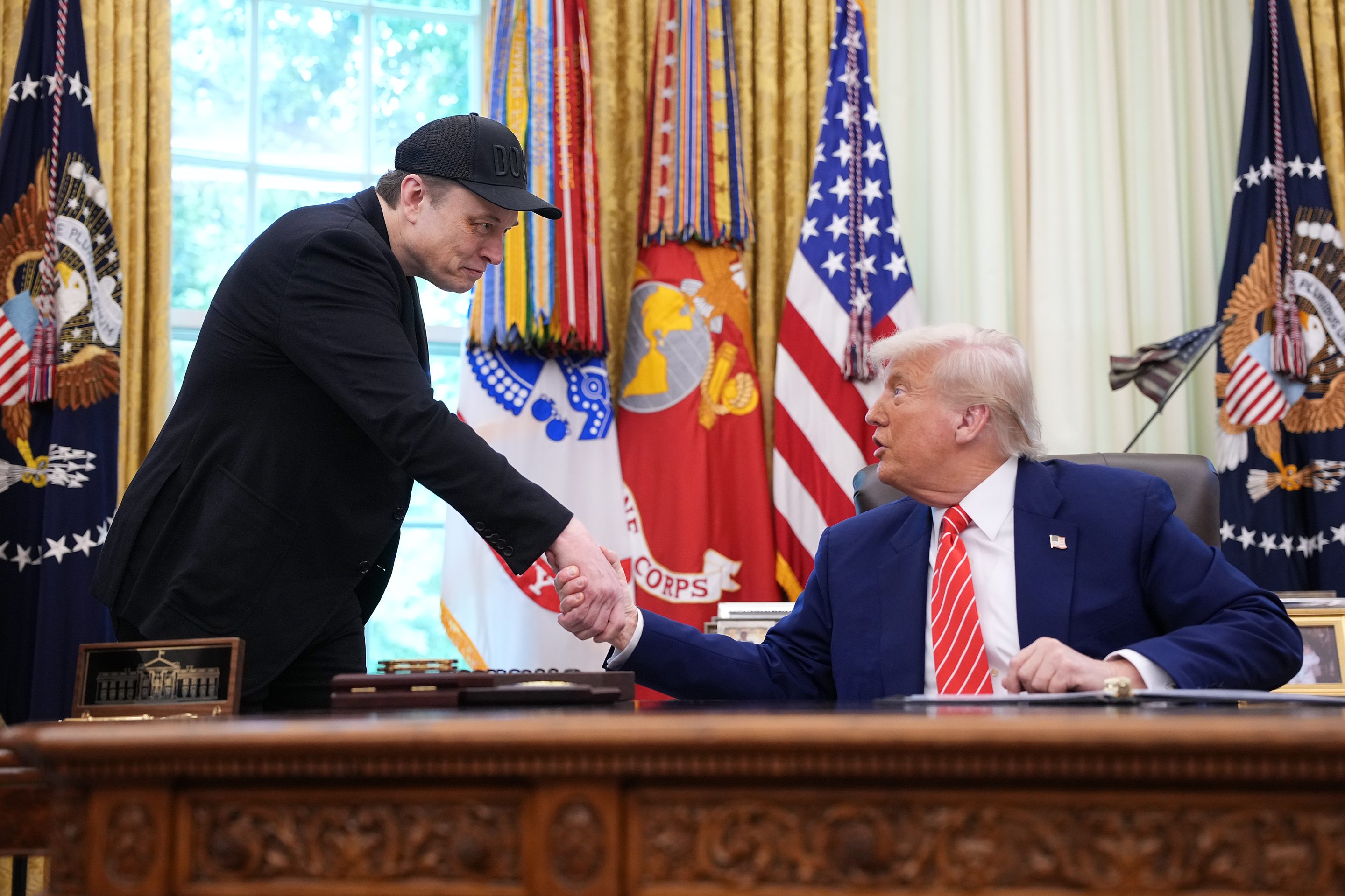 Elon Musk shakes hands with U.S. President Donald Trump as they speak to reporters in the Oval Office of the White House on May 30, 2025 in Washington, DC.