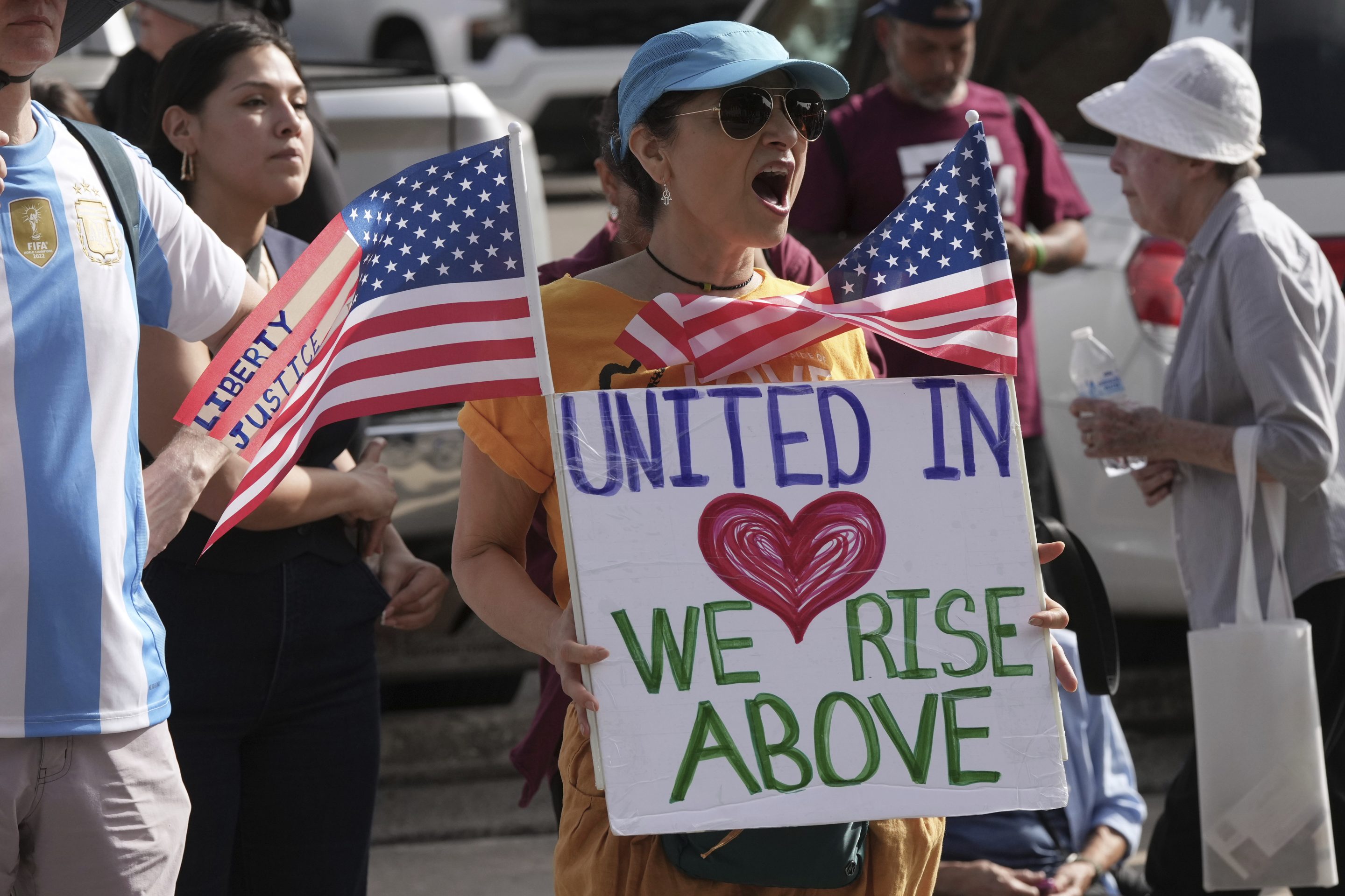 Immigration advocates protest recent detentions by ICE outside the immigration court in San Antonio, on July 1, 2025. 