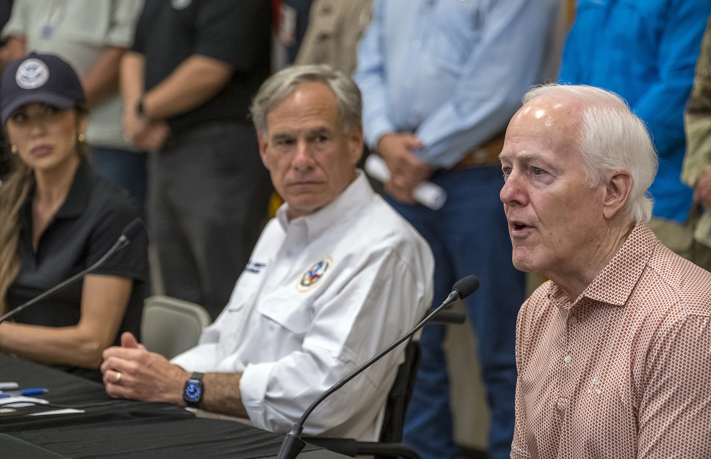 Sen. John Cornyn (right), Homeland Security Secretary Kristi Noem (left), and Gov. Greg Abbott (center) during a press conference on Saturday.