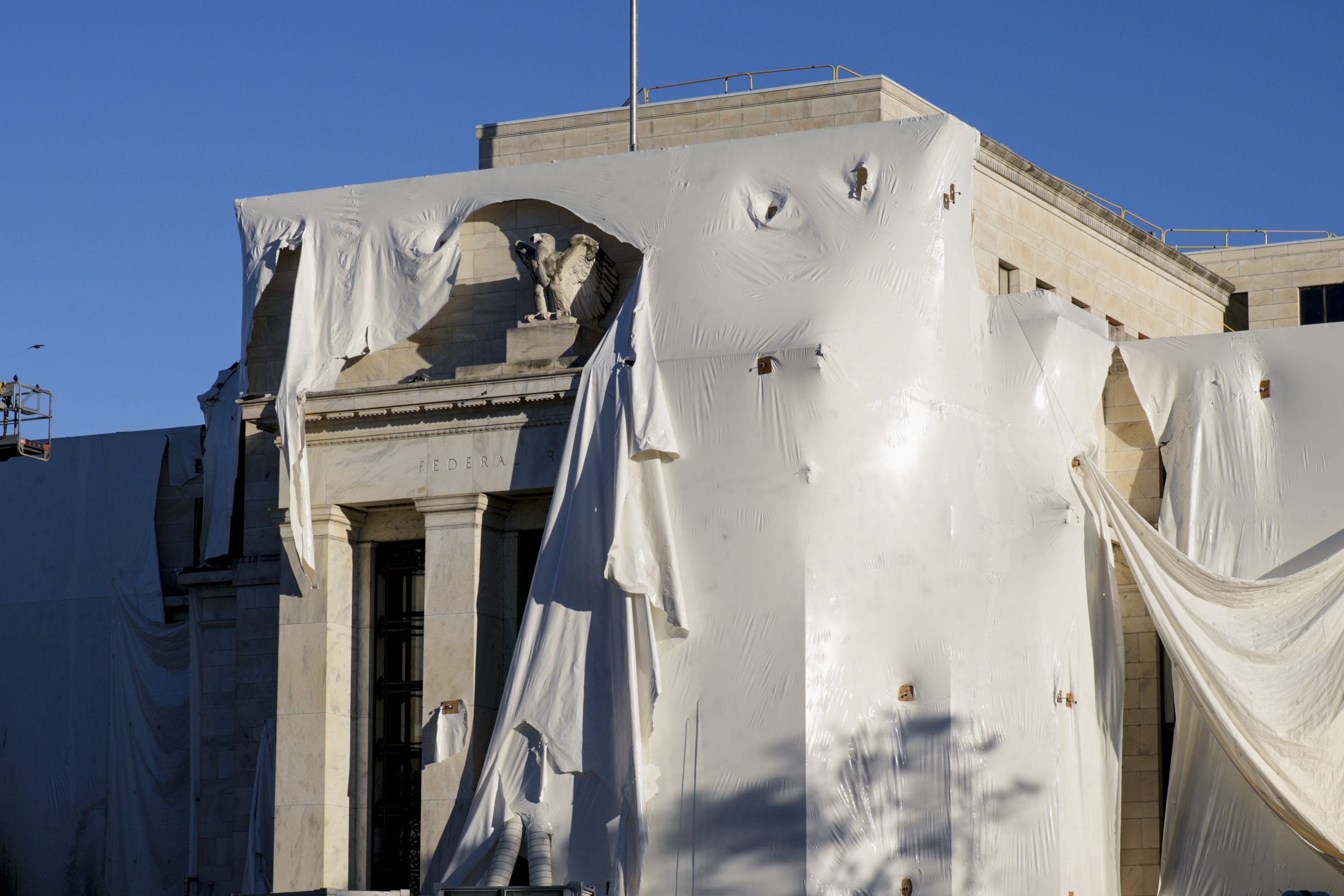 Protective construction wrapping on the facade of the Federal Reserve in 2023.