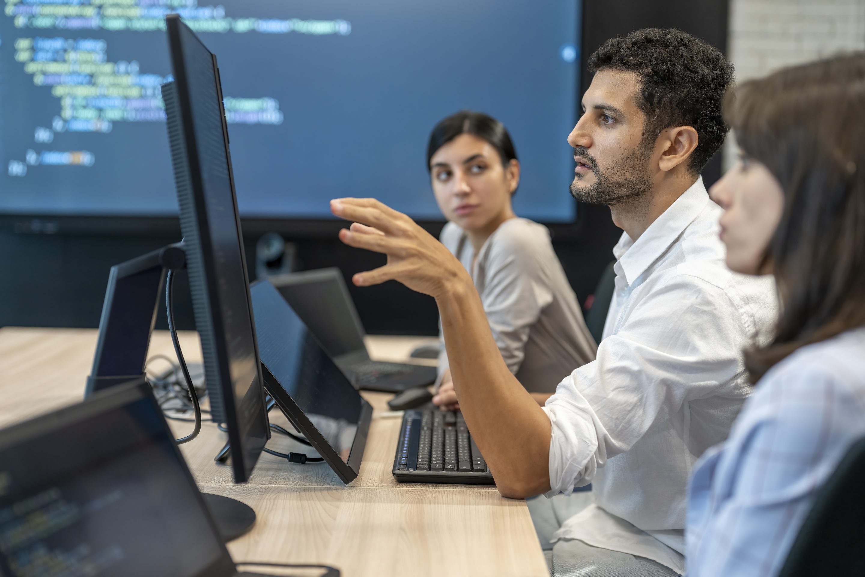Workers discussing a business problem behind screens