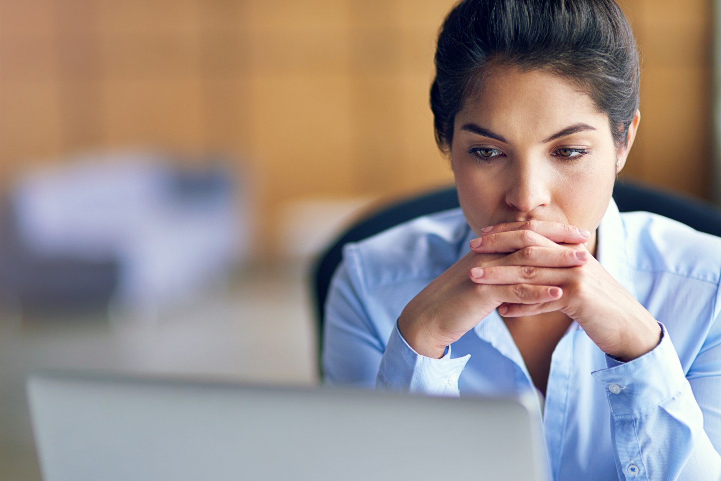 Shot of an executive looking stressed while working on her computer