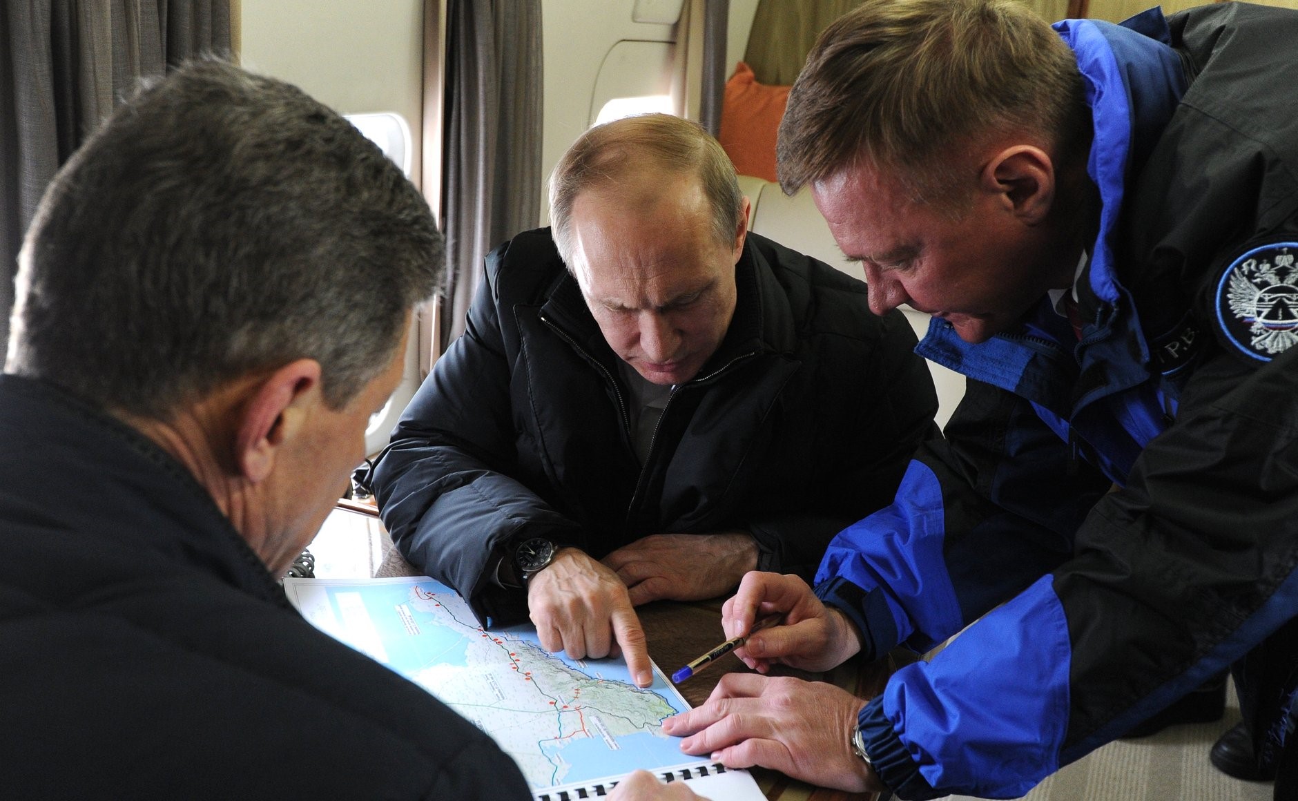 SEVASTOPOL, CRIMEA - MARCH 18: Russia's president Vladimir Putin (C), deputy prime minister Dmitry Kozak (L front), and the head of Russia's Federal Road Agency (Rosavtodor), Roman Starovoit look at a map of Crimea on a helicopter as they survey the area around the Strait of Kerch.