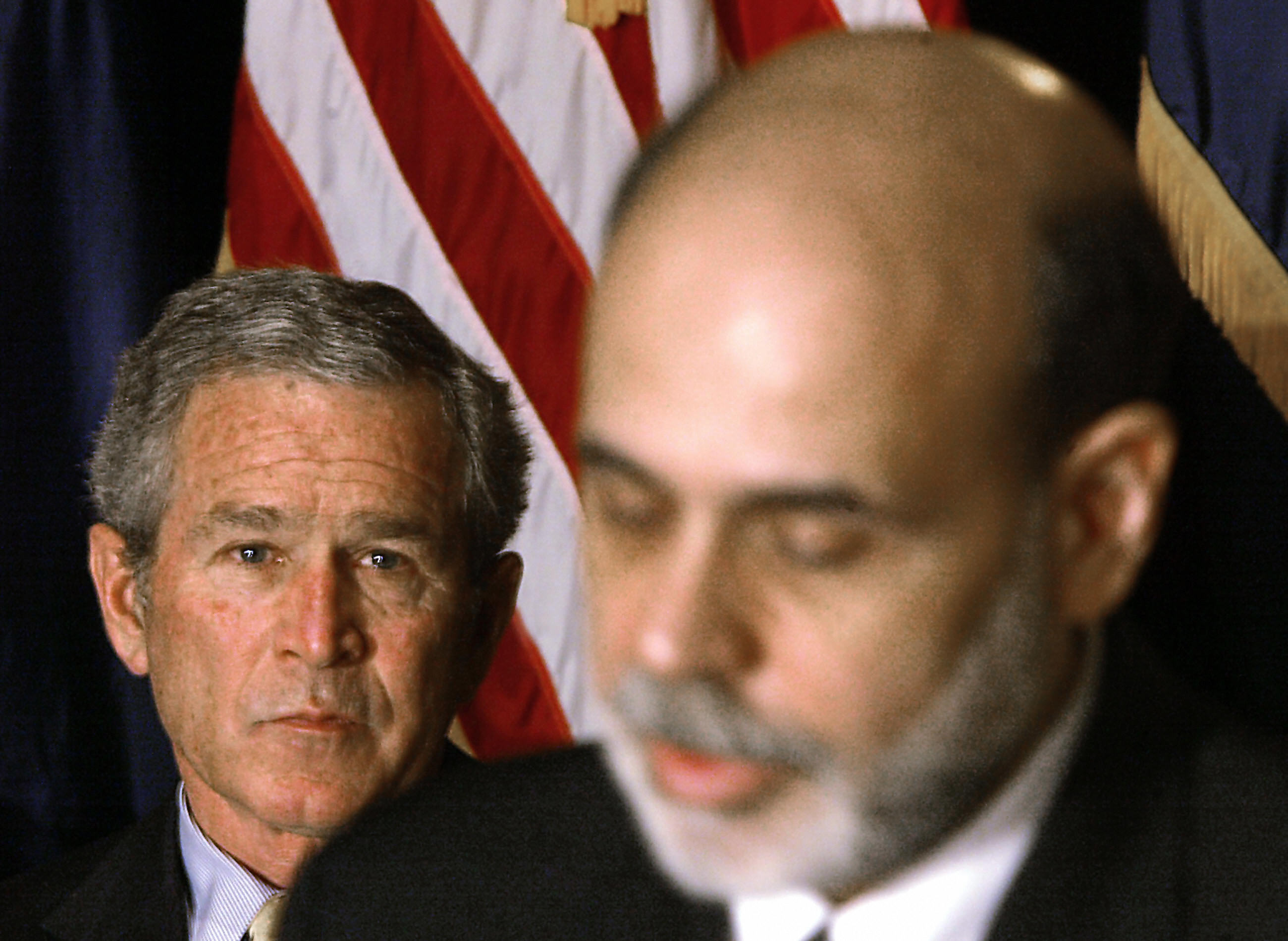 President George W. Bush (L) looks on as Ben Bernanke (R) speaks after he was sworn in as the 14th Federal Reserve Chairman at the Federal Reserve in Washington, DC, 06 February 2006.