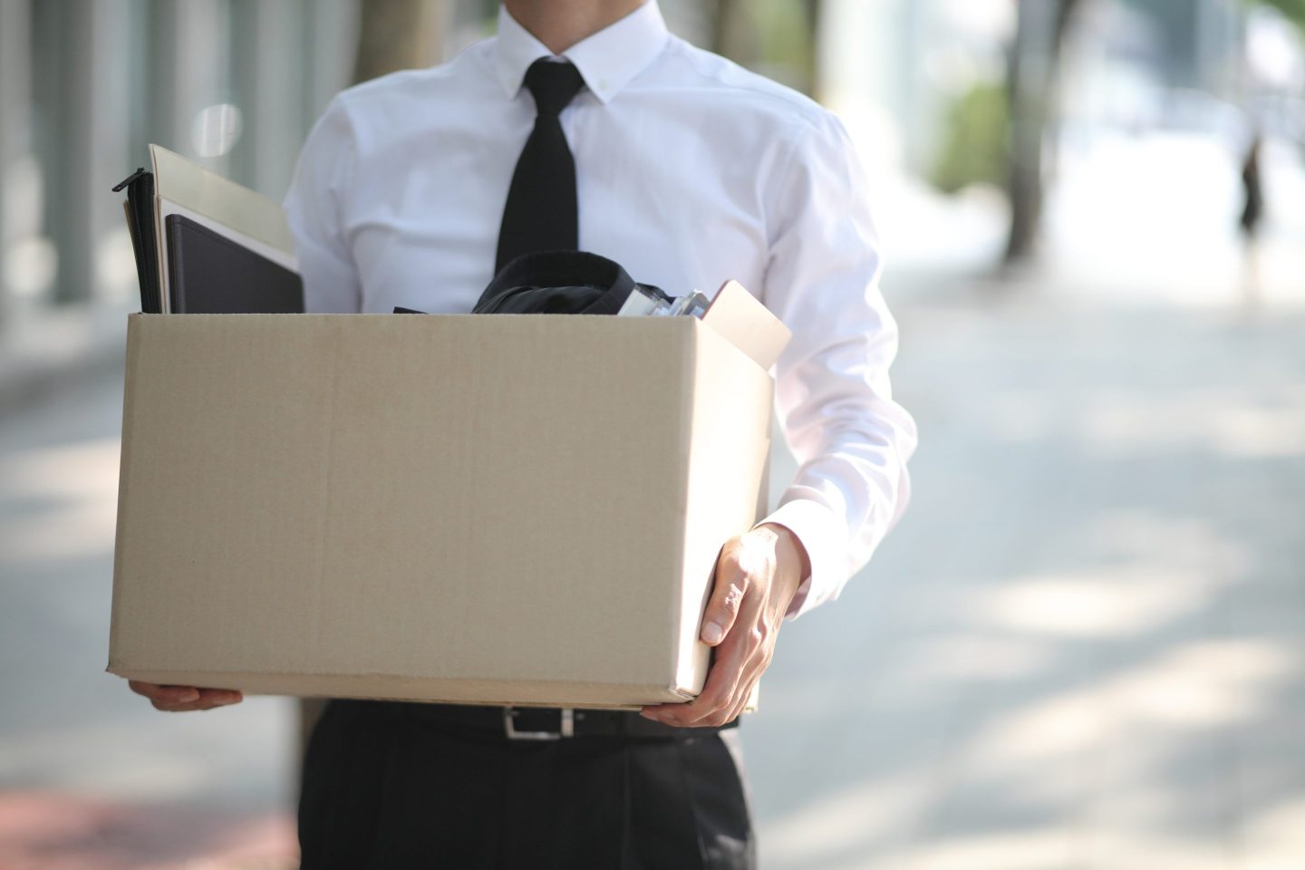 A man holding a box of his office things