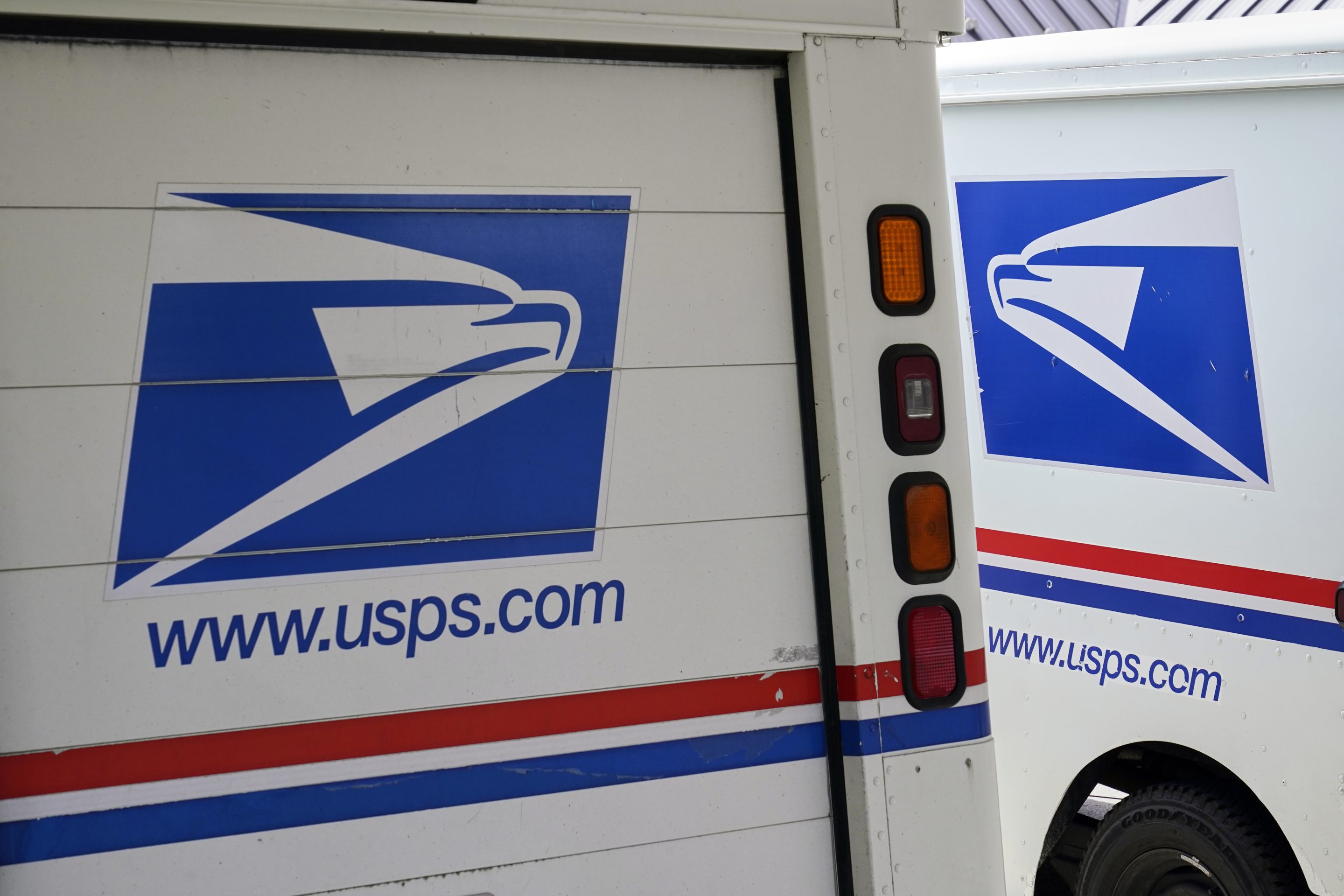 U.S. Postal Service delivery vehicles parked outside a post office in Boys Town, Neb.