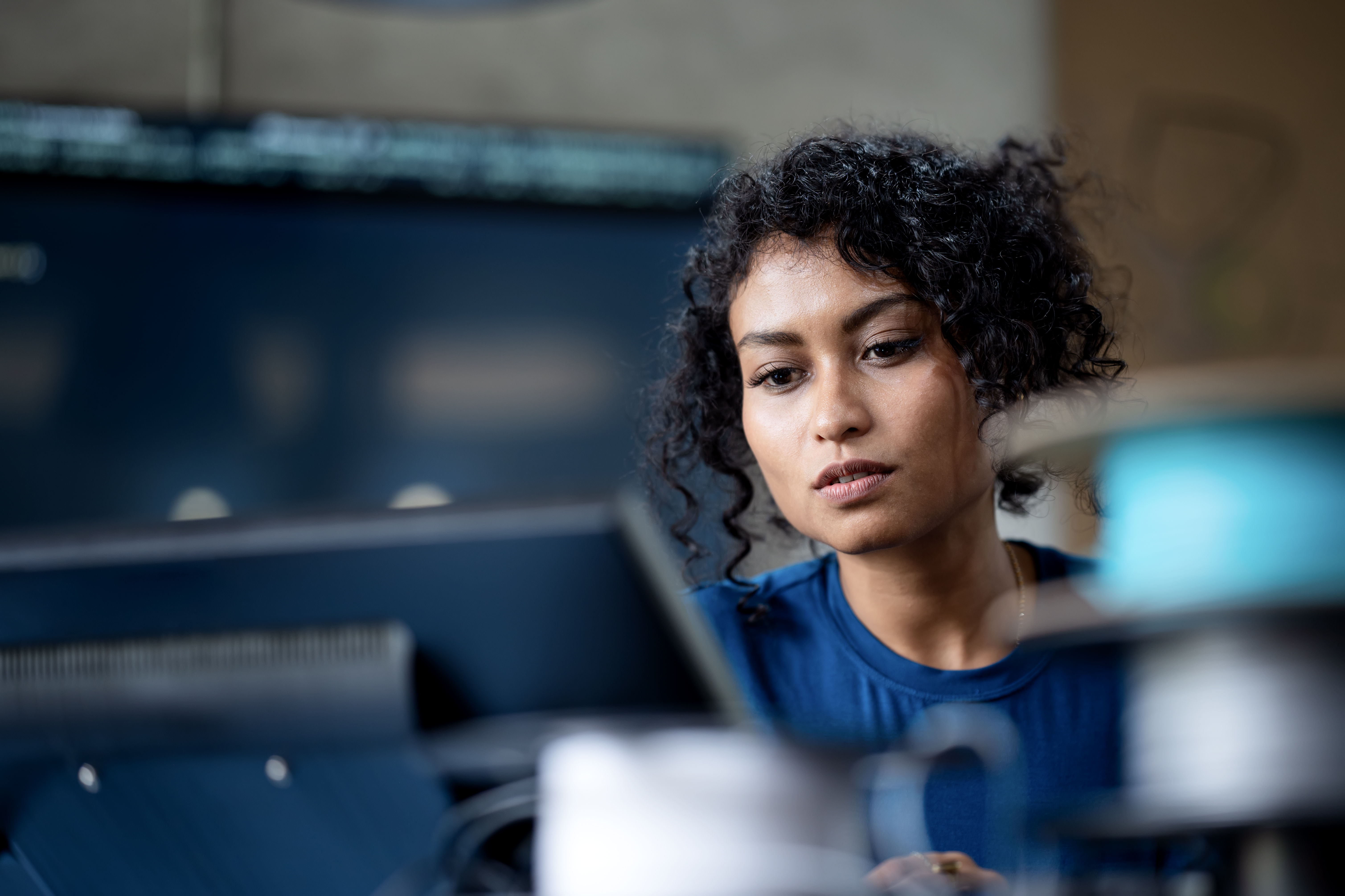 Tech worker looking at a computer.