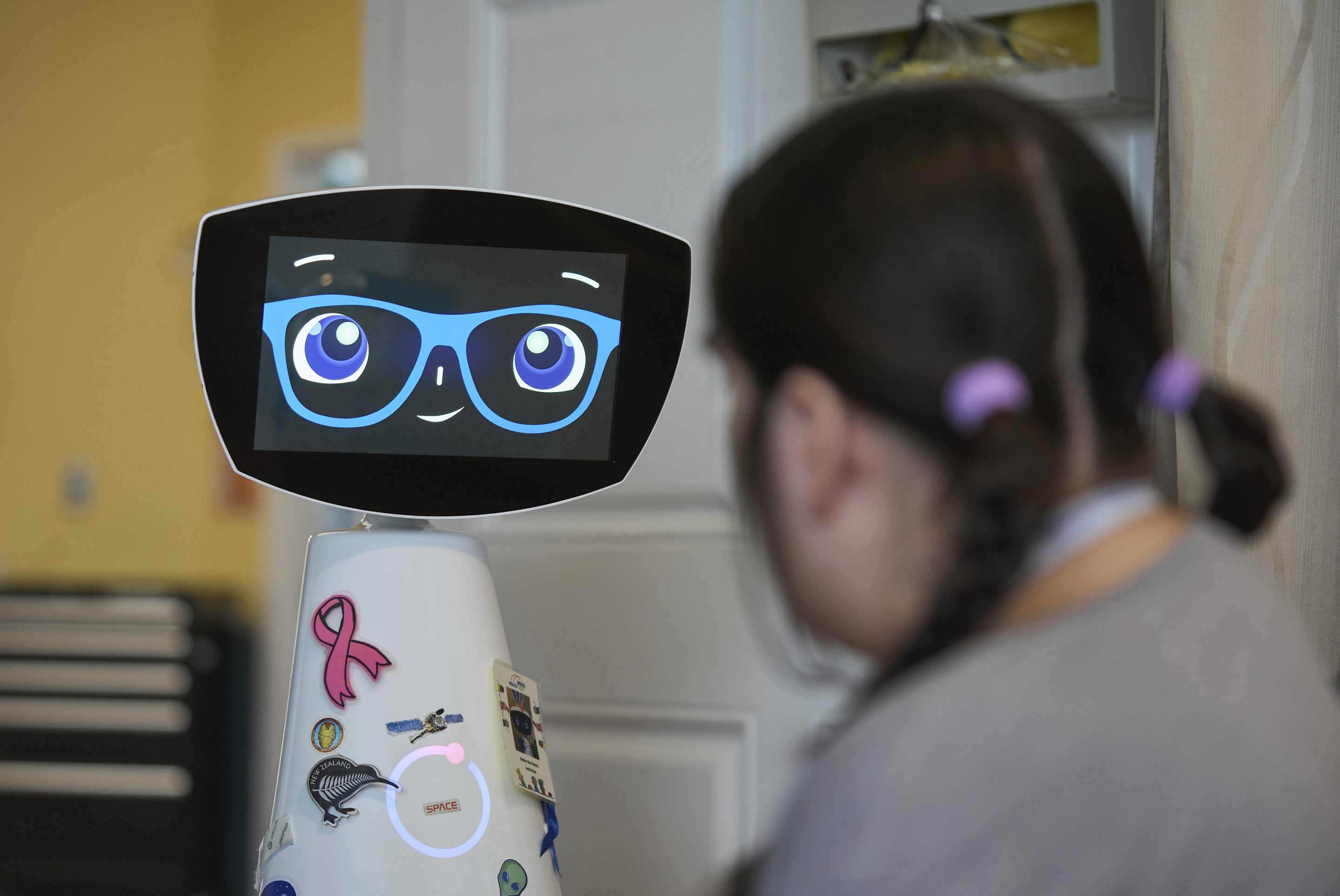 A therapy robot named Robin talks to a child in a hospital