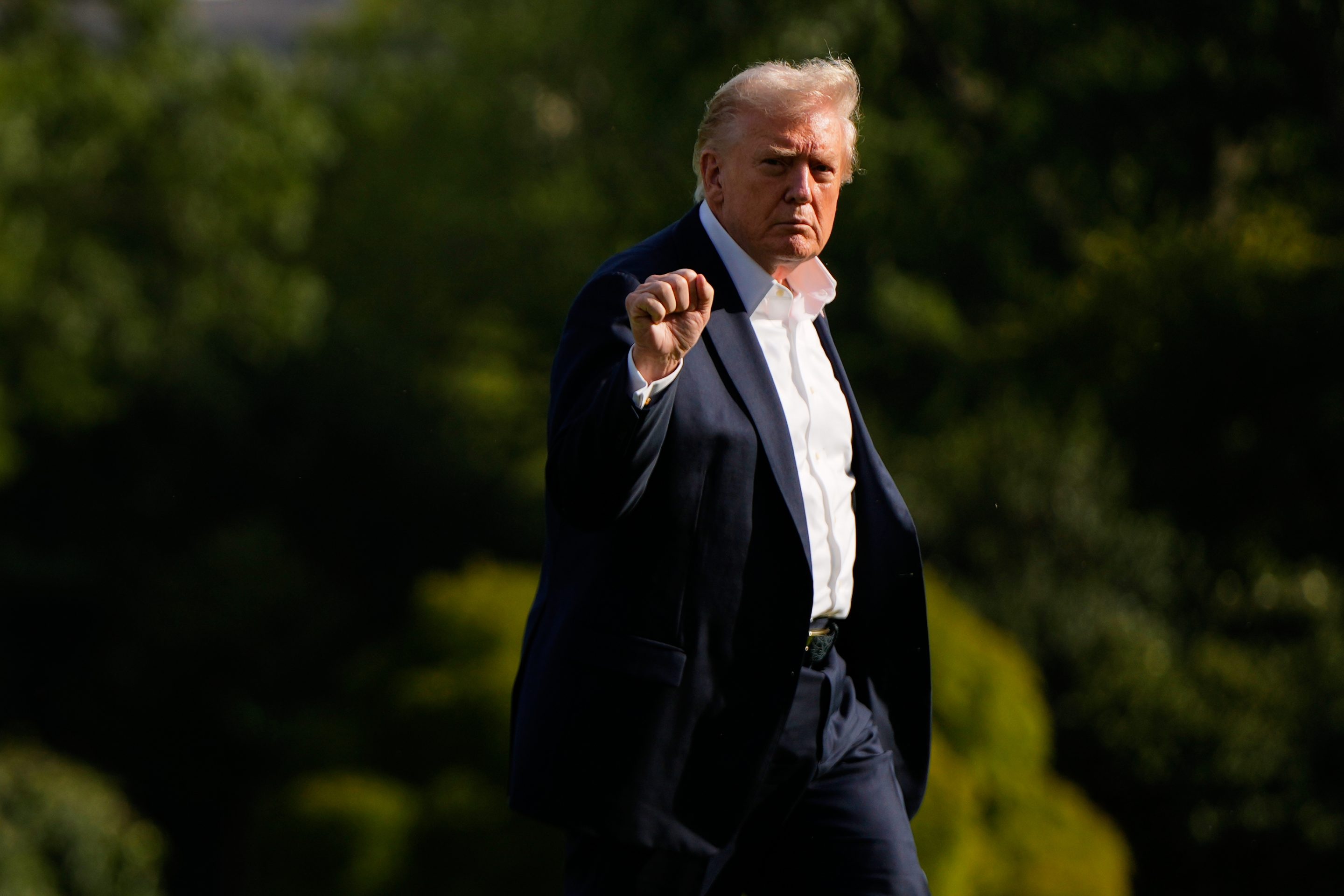 President Donald Trump gestures as he arrives at the White House on Friday.