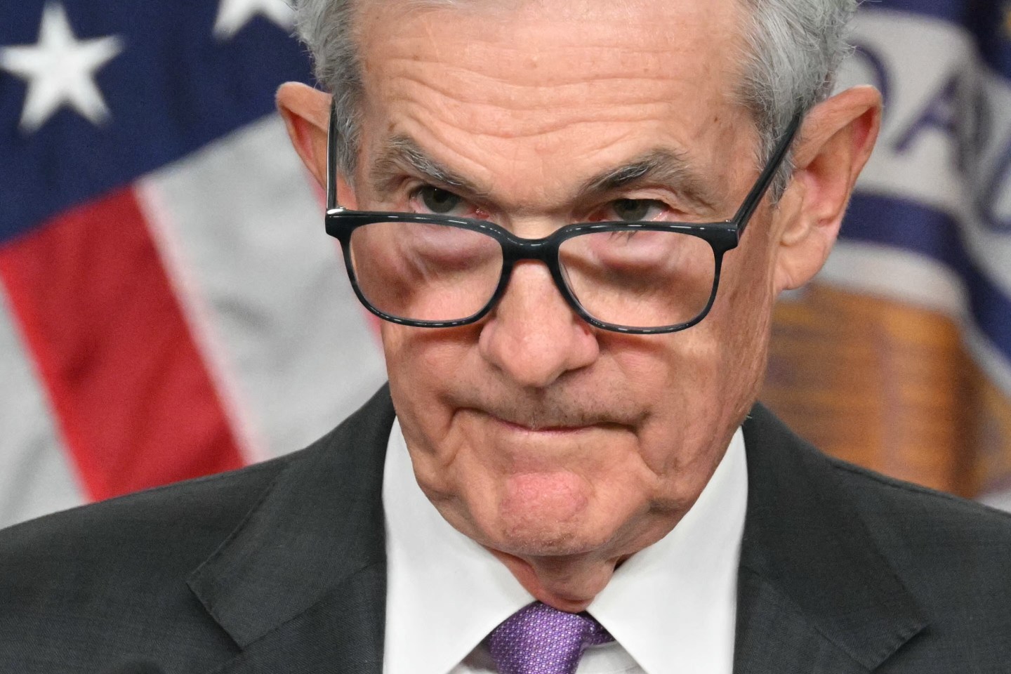 Close up photo of Jerome Powell looking over his glasses.