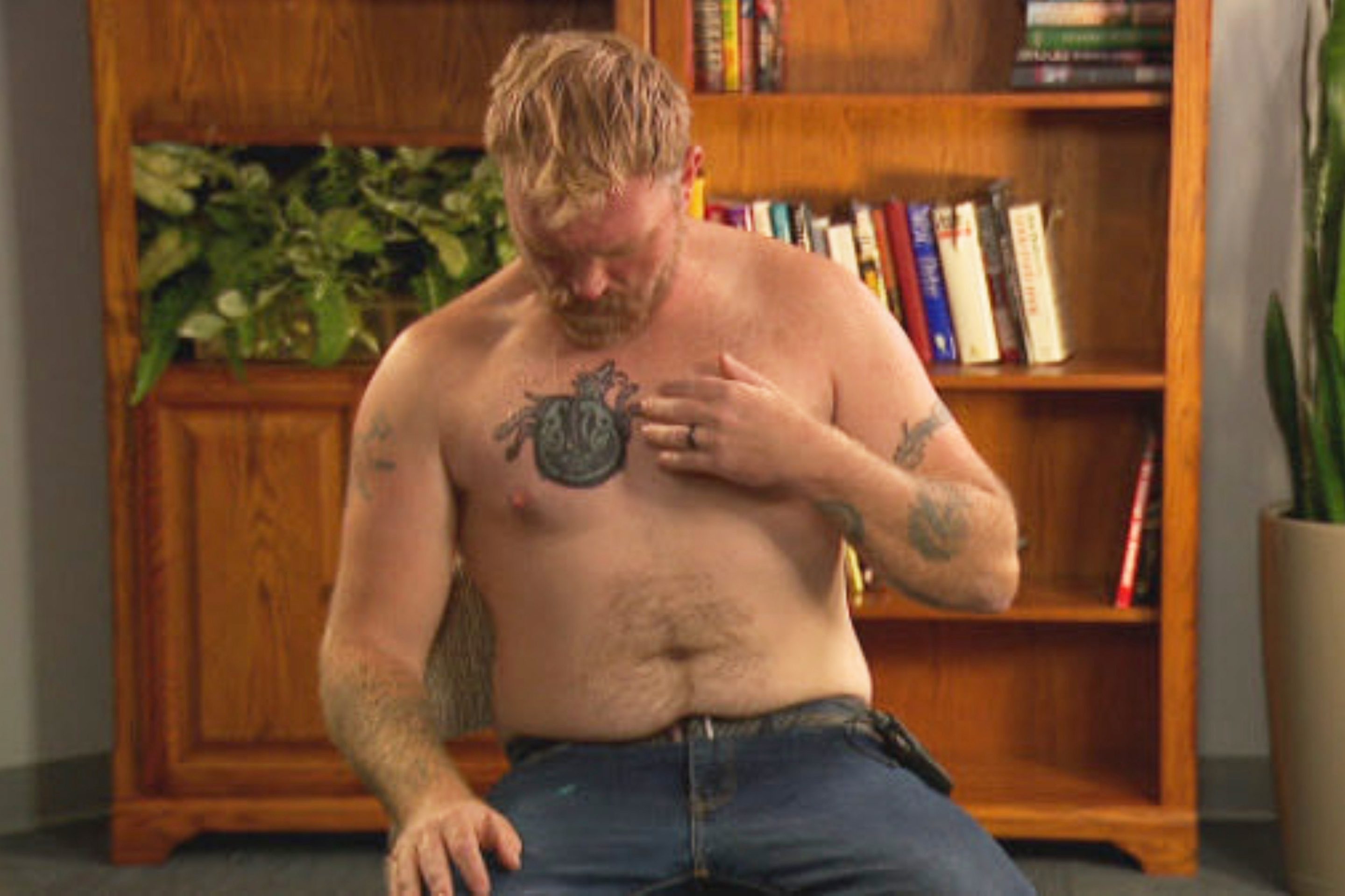 Graham Platner, a democratic candidate for U.S. Senate, points to a cover-up tattoo that had previously been an image recognized as a Nazi symbol, during an interview on Wednesday, Oct. 22, 2025, in Portland, Maine.
