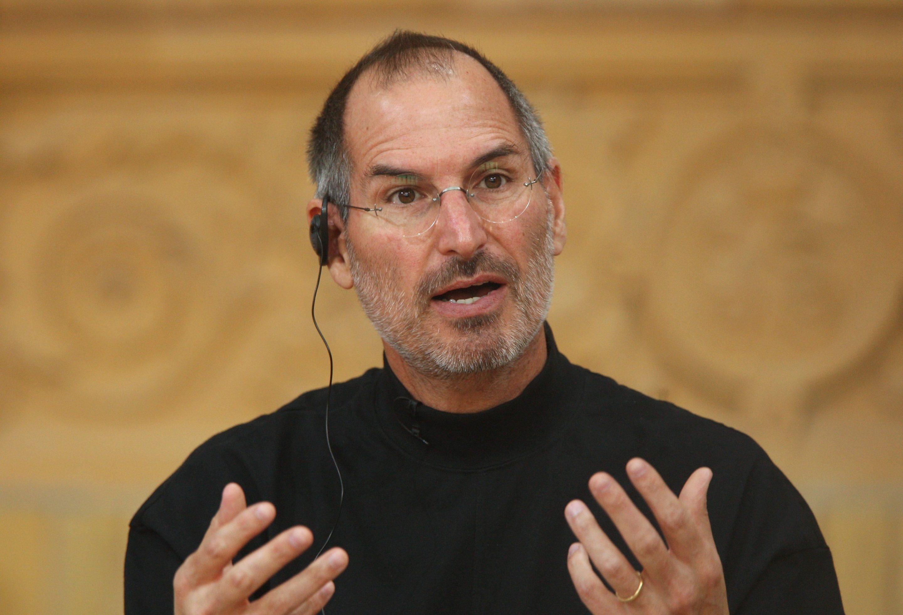 Steve Jobs holds up his hands while speaking