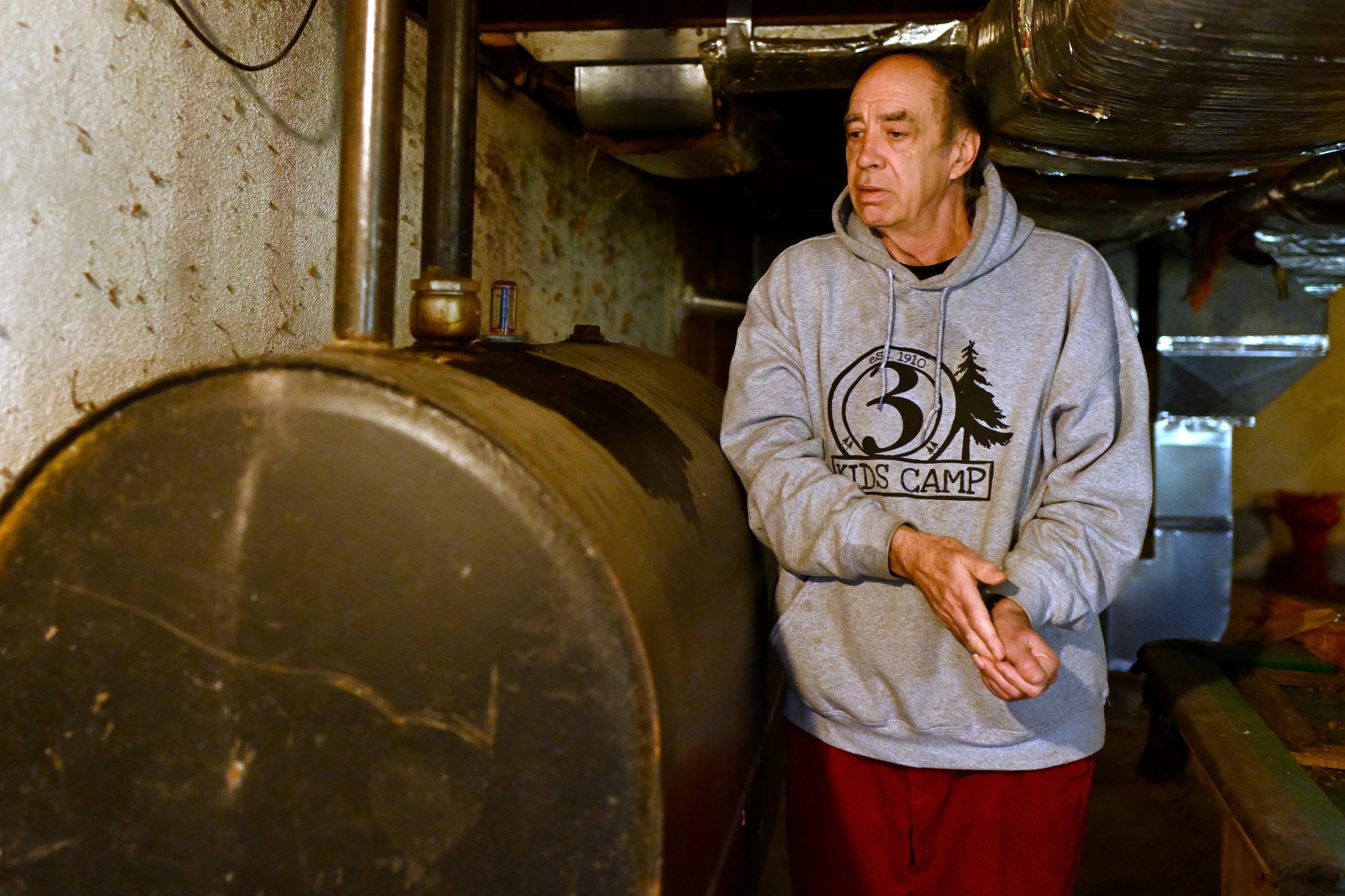 Mark Bain, who is part of the Low Income Home Energy Assistance Program, rubs his hands together as he checks the level on his oil at home in hopes that he will have enough oil to outlast the shutdown, in Bloomfield, Conn., on Oct. 27, 2025.
