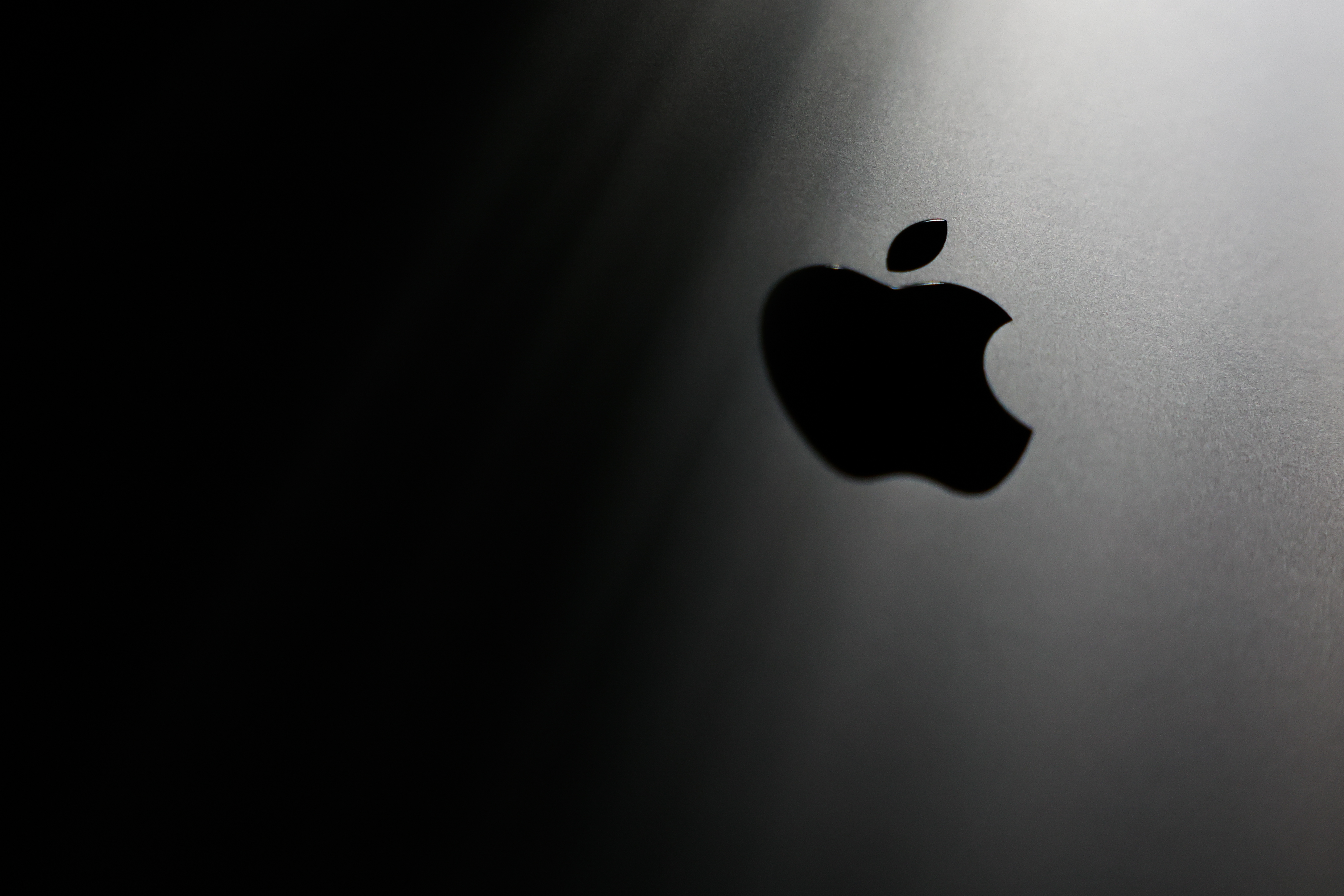 An Apple logo appearing on a MacBook laptop in 2025. (Photo: Jakub Porzycki/NurPhoto/Getty Images)