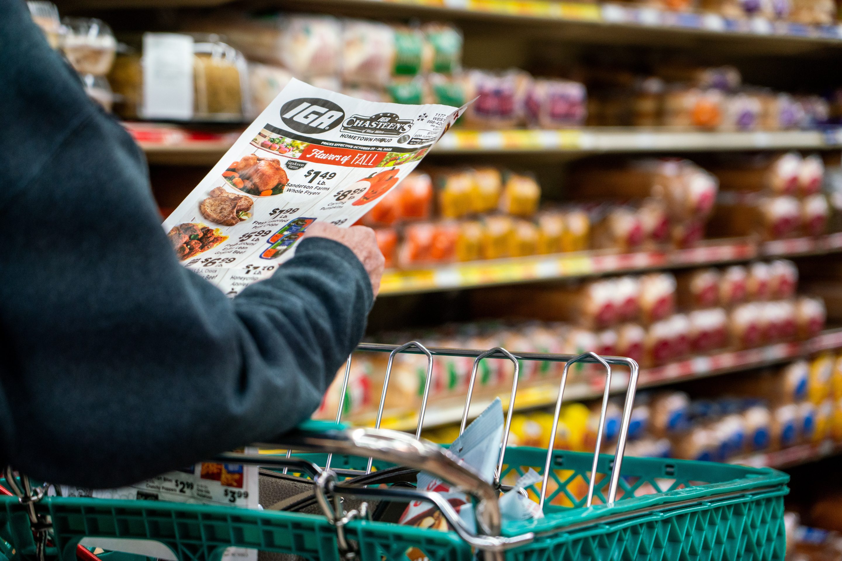 A shopper looks at a sales advertisement at a grocery store in West Milton, Ohio, on Tuesday, Oct. 21, 2025. 