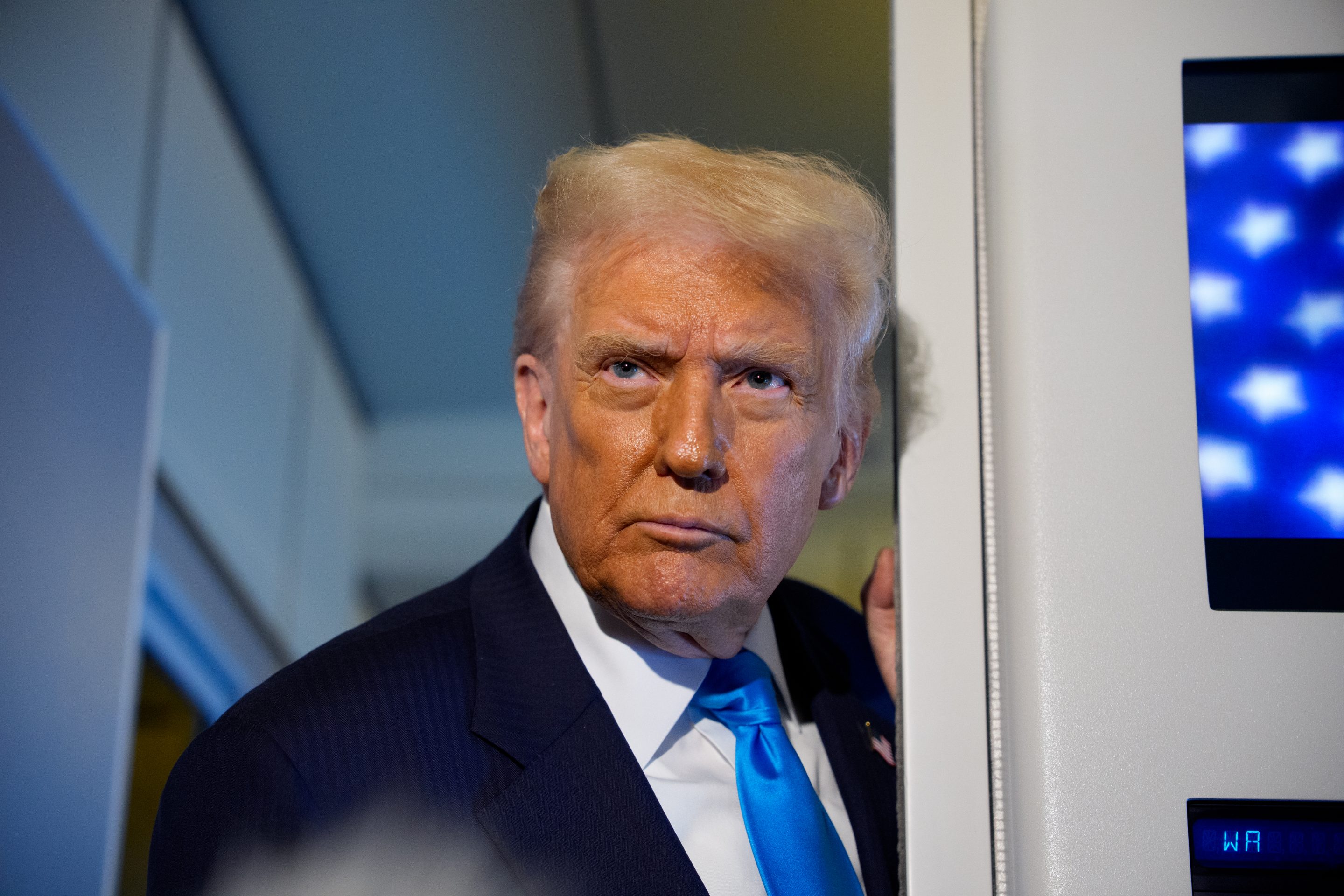 U.S. President Donald Trump speaks to journalists aboard Air Force One en route to South Korea on October 29, 2025 in Japan.