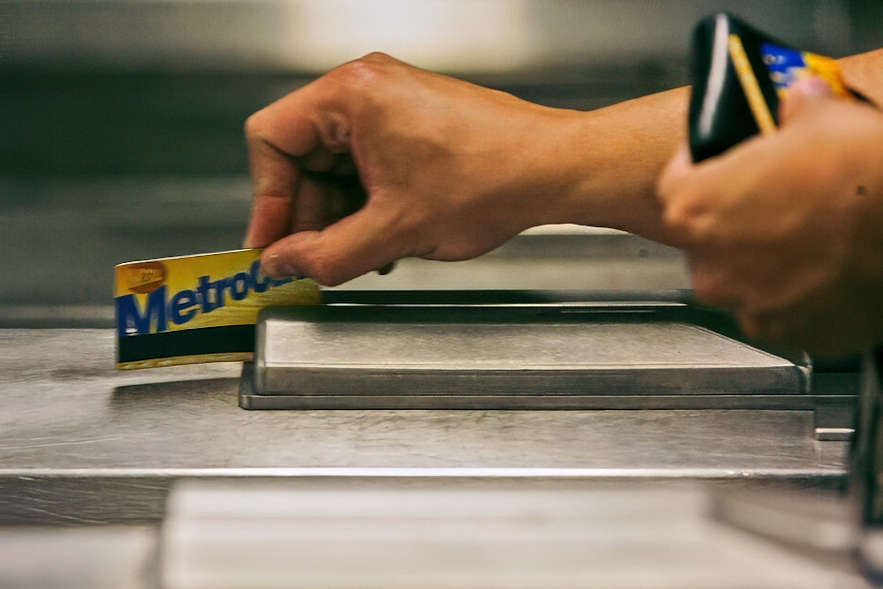 A subway rider swipes his MetroCard in a turnstile as he enters the 34th St. subway station, July 23, 2007, in New York. 