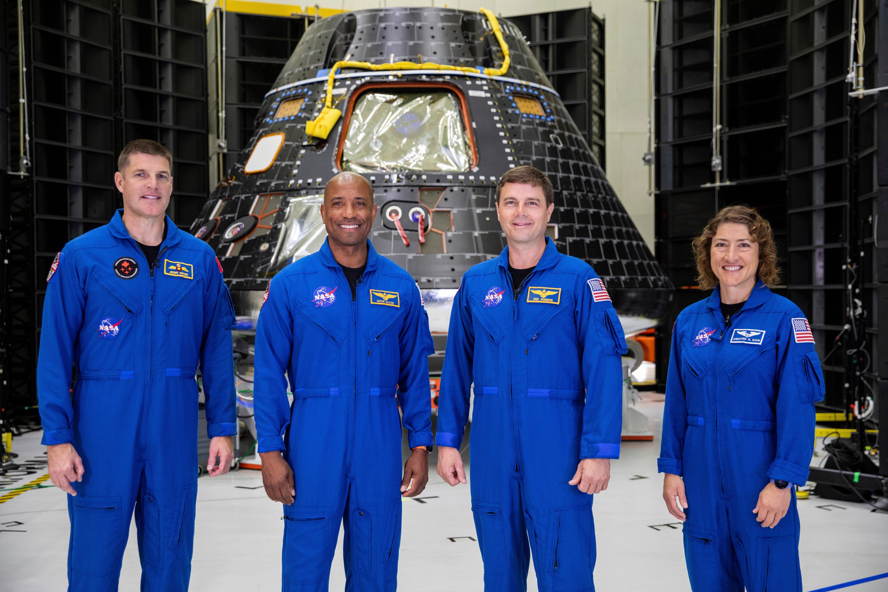 Artemis II crew members, from left, Jeremy Hansen, Victor Glover, Reid Wiseman and Christina Koch, stand together at NASA's Kennedy Space Center in Florida, in front of an Orion crew module on Tuesday, Aug. 8, 2023.