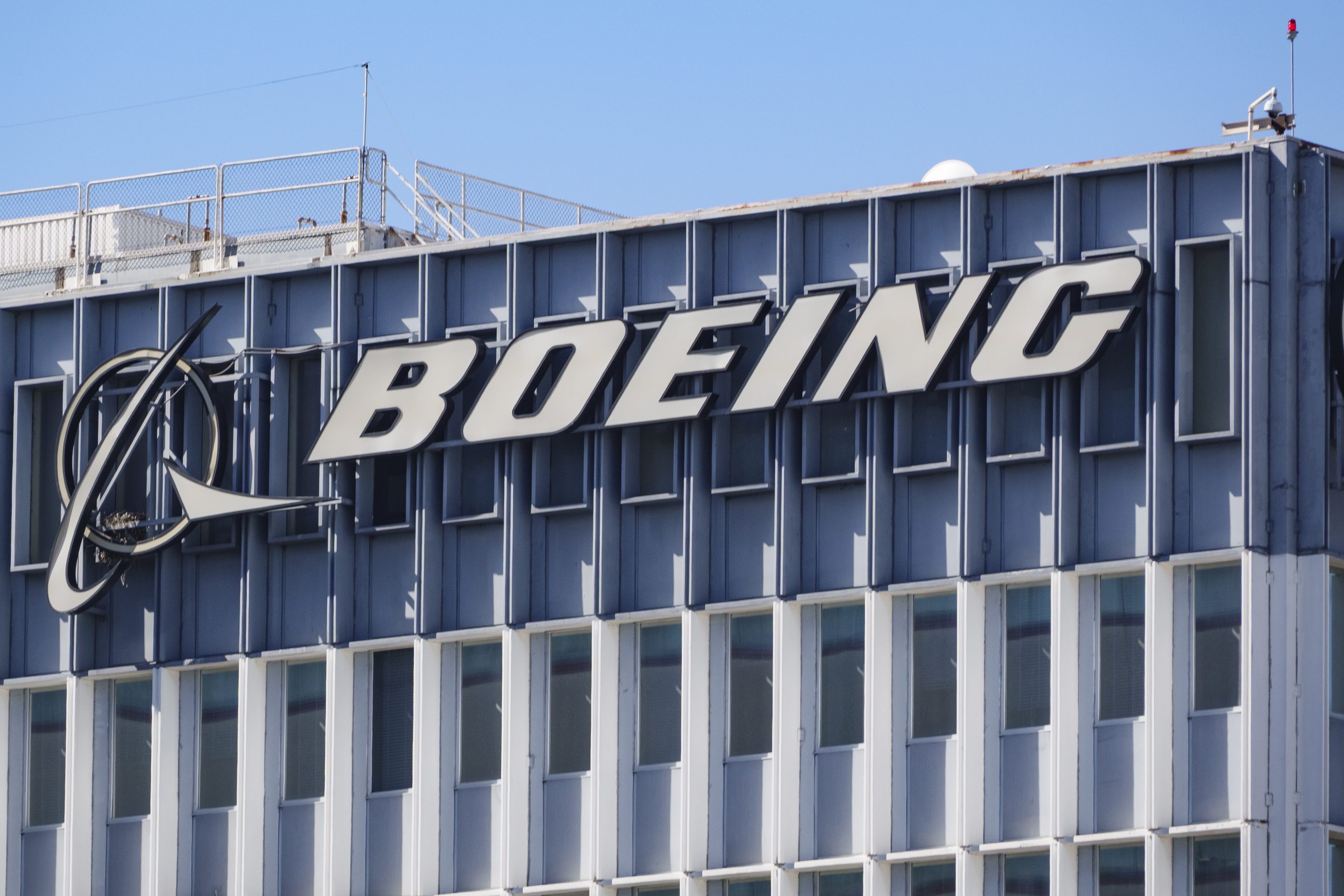 The Boeing logo is displayed on a sign at their building.