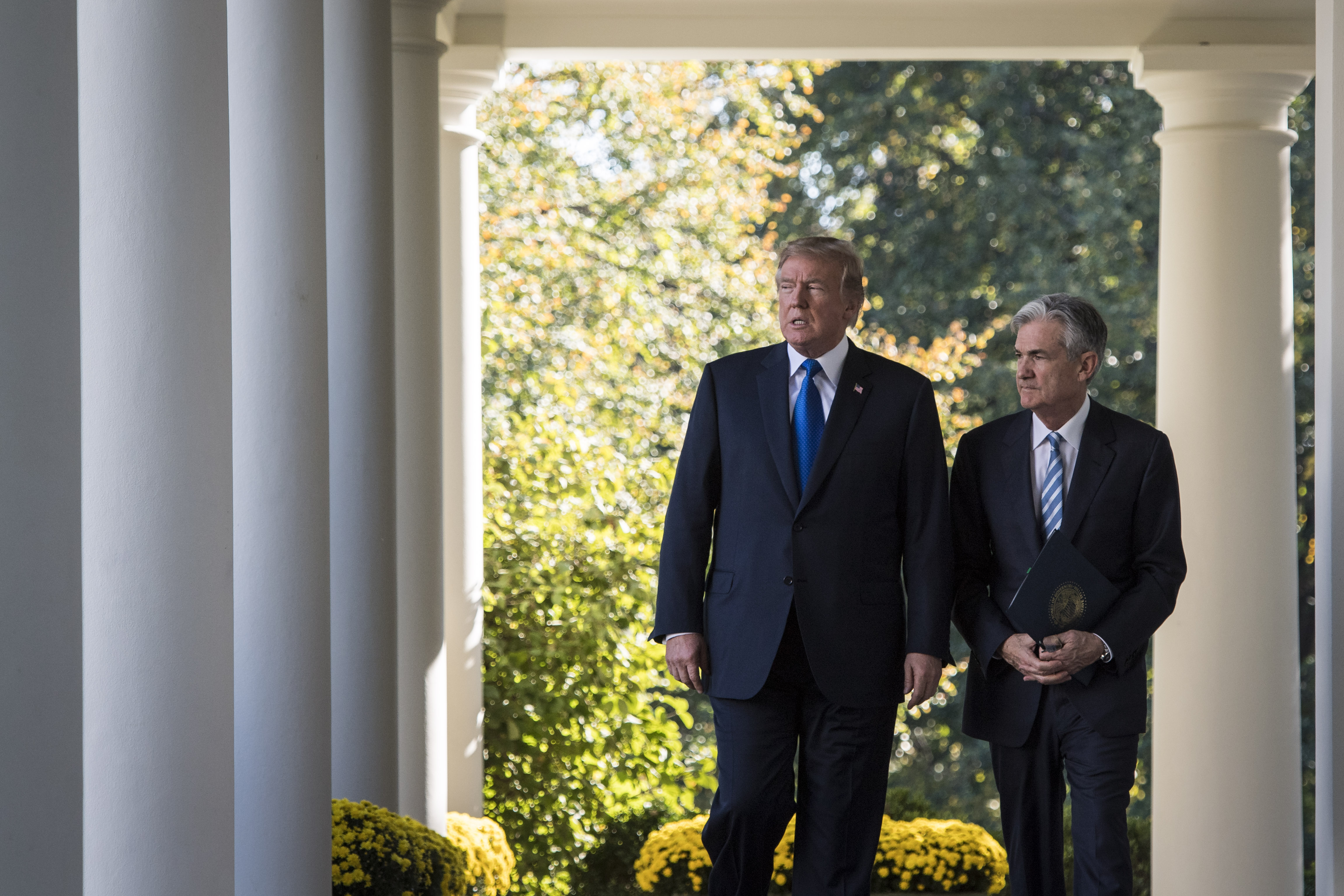 President Donald Trump walks out with Federal Reserve board member Jerome Powell