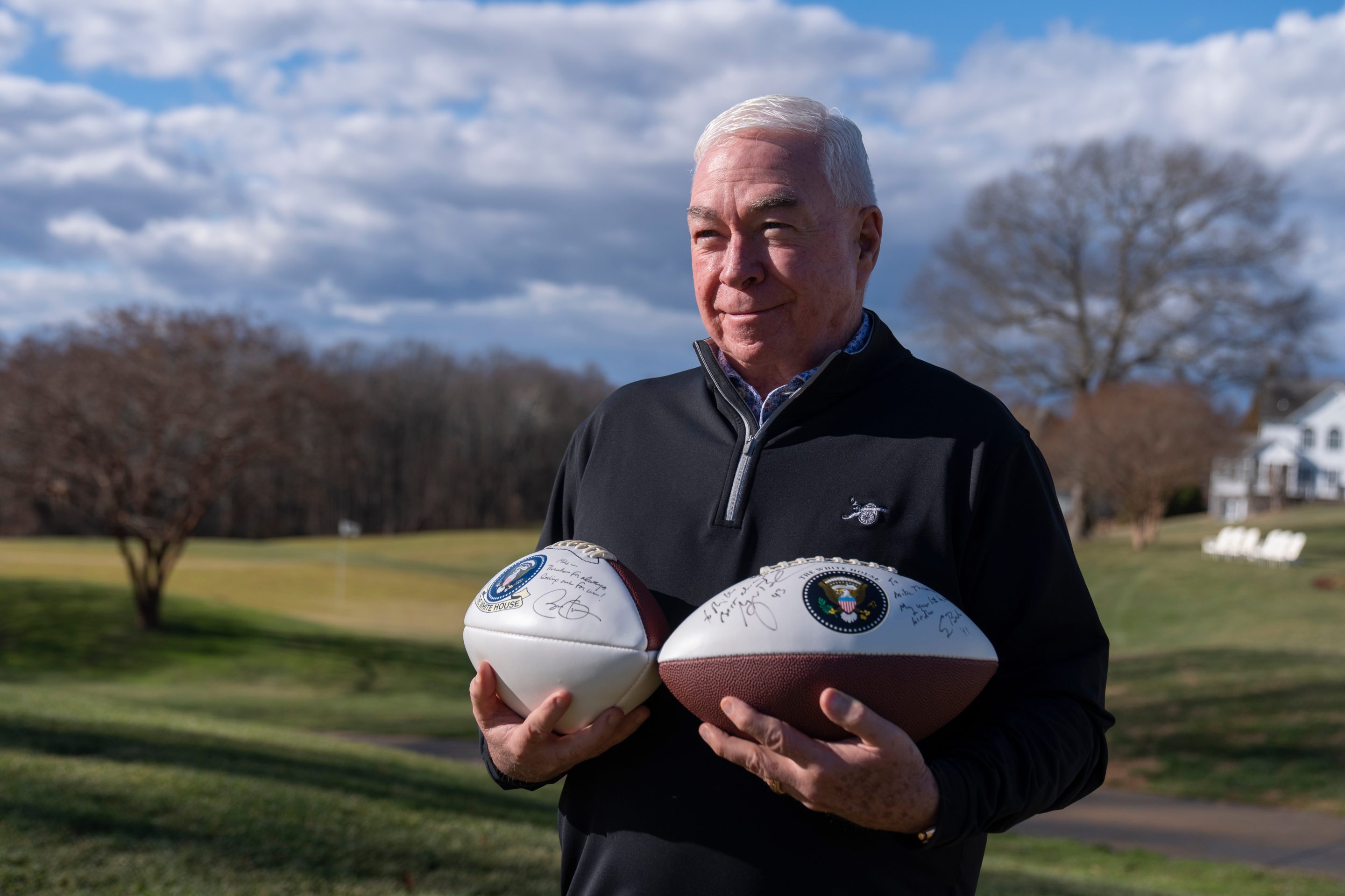 Michael Thomas, the former manager of the Courses at Andrews at Joint Base Andrews, stands with footballs autographed by several former presidents, Friday, Dec. 19, 2025, in Lothian, Md.