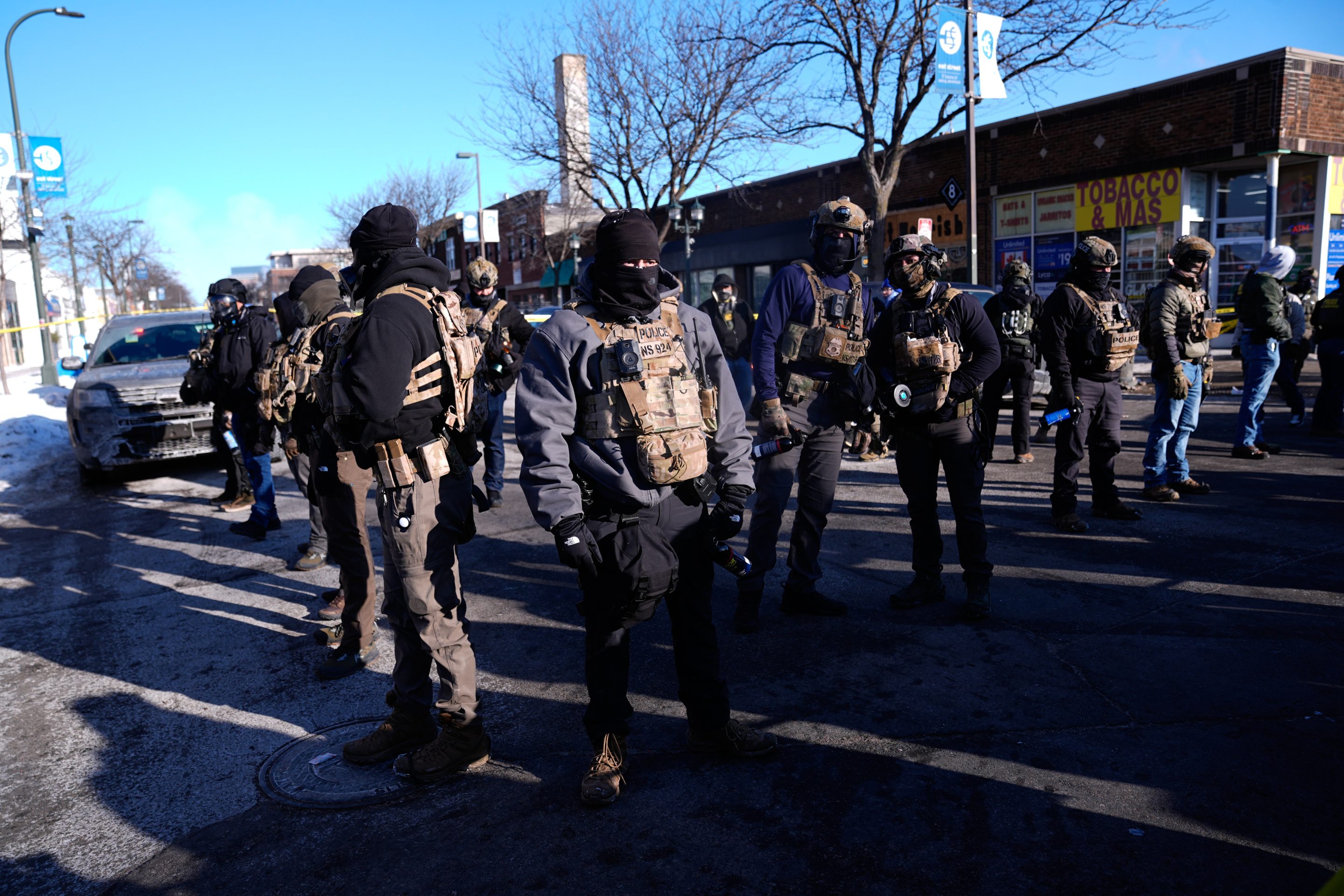 Federal agents stand near the site of a shooting Saturday, Jan. 24, 2026, in Minneapolis.