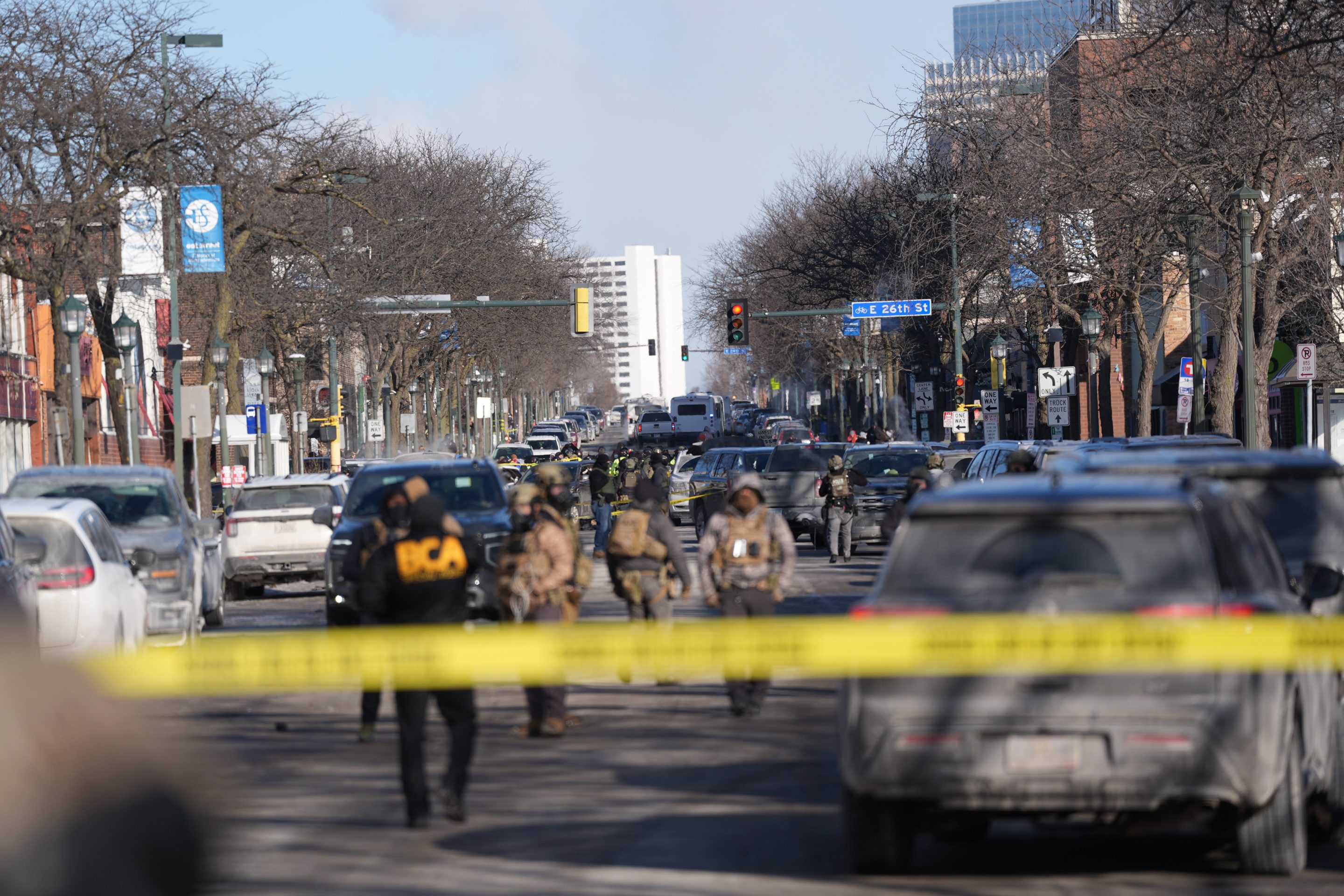 Federal agents stand near the site of a shooting Saturday, Jan. 24, 2026, in Minneapolis.