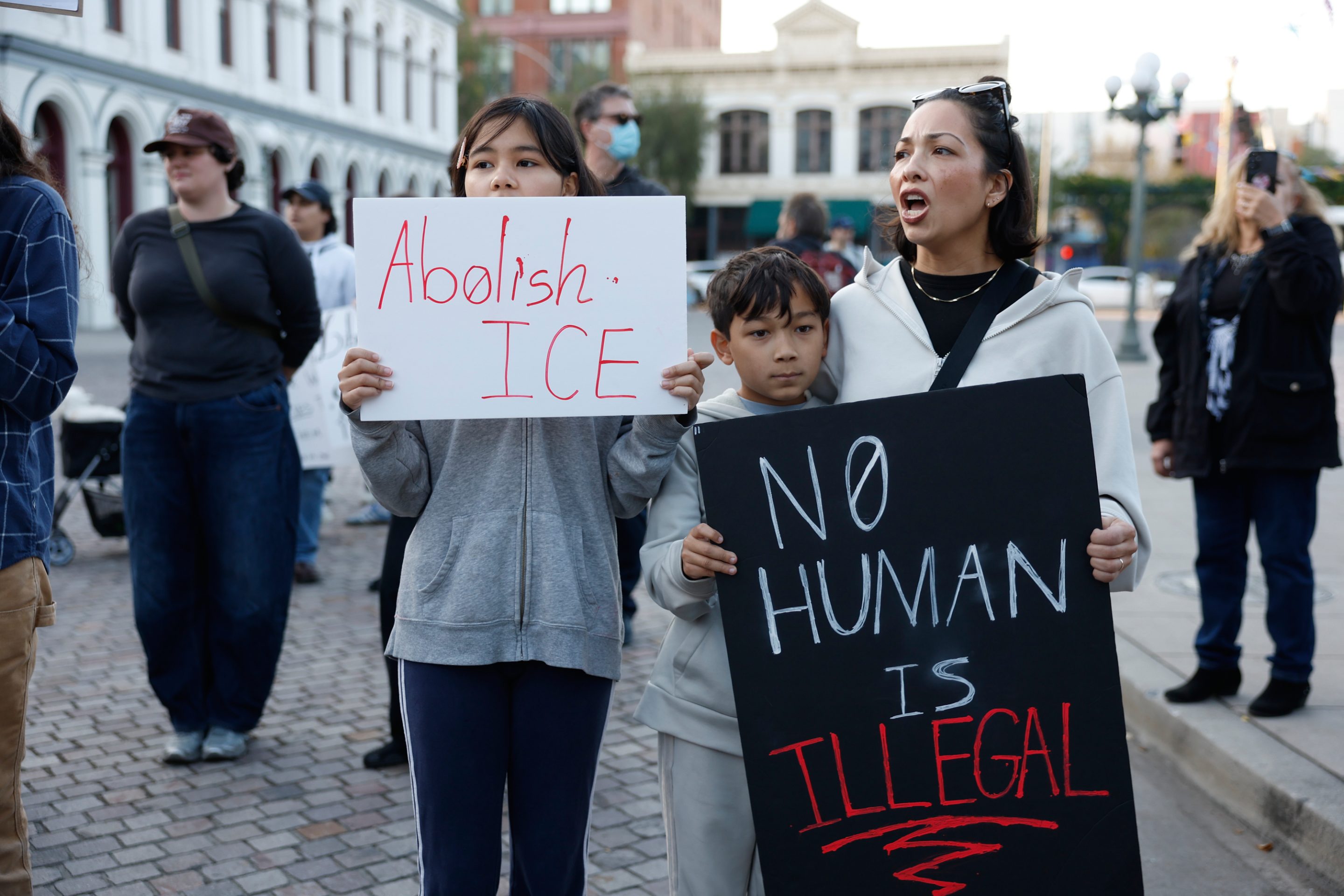 Demonstrators hold signs during a protest in response to the fatal shooting of 37-year-old Alex Pretti in Minneapolis earlier in the day Saturday, Jan. 24, 2026, in Los Angeles.
