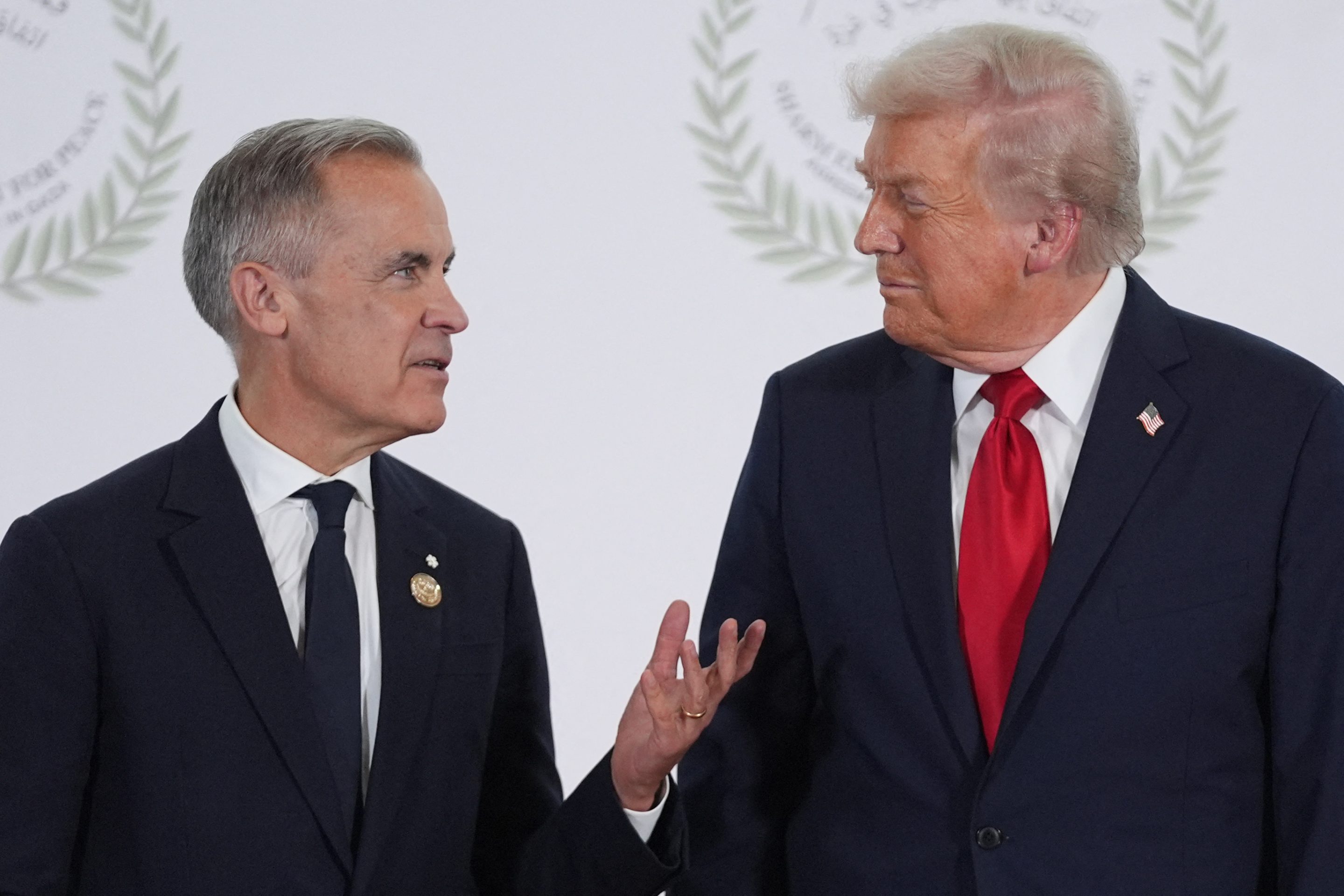 President Donald Trump greets Canadian Prime Minister Mark Carney during a summit on Gaza in Sharm el-Sheikh on October 13, 2025.