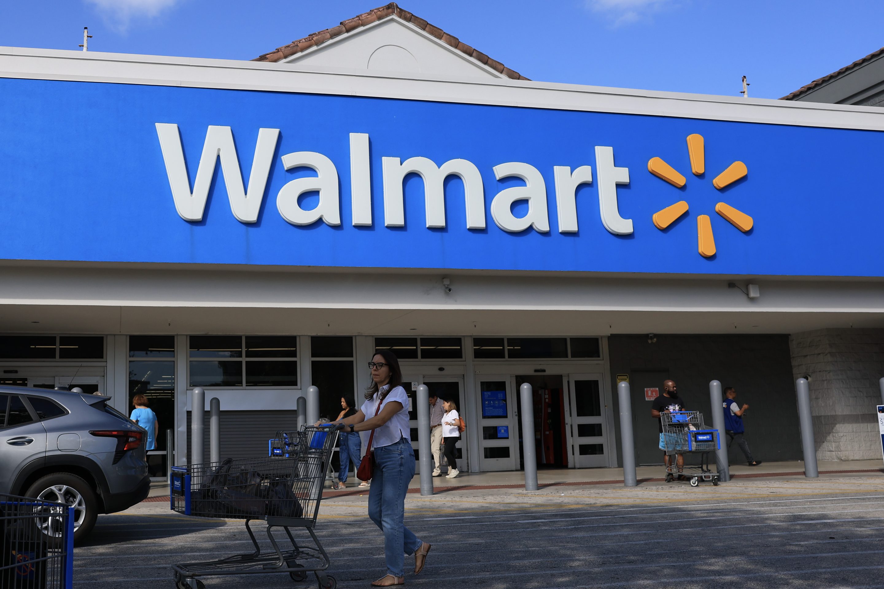 A Walmart sign hangs on the exterior of the store on November 20, 2025 in Hollywood, Florida.