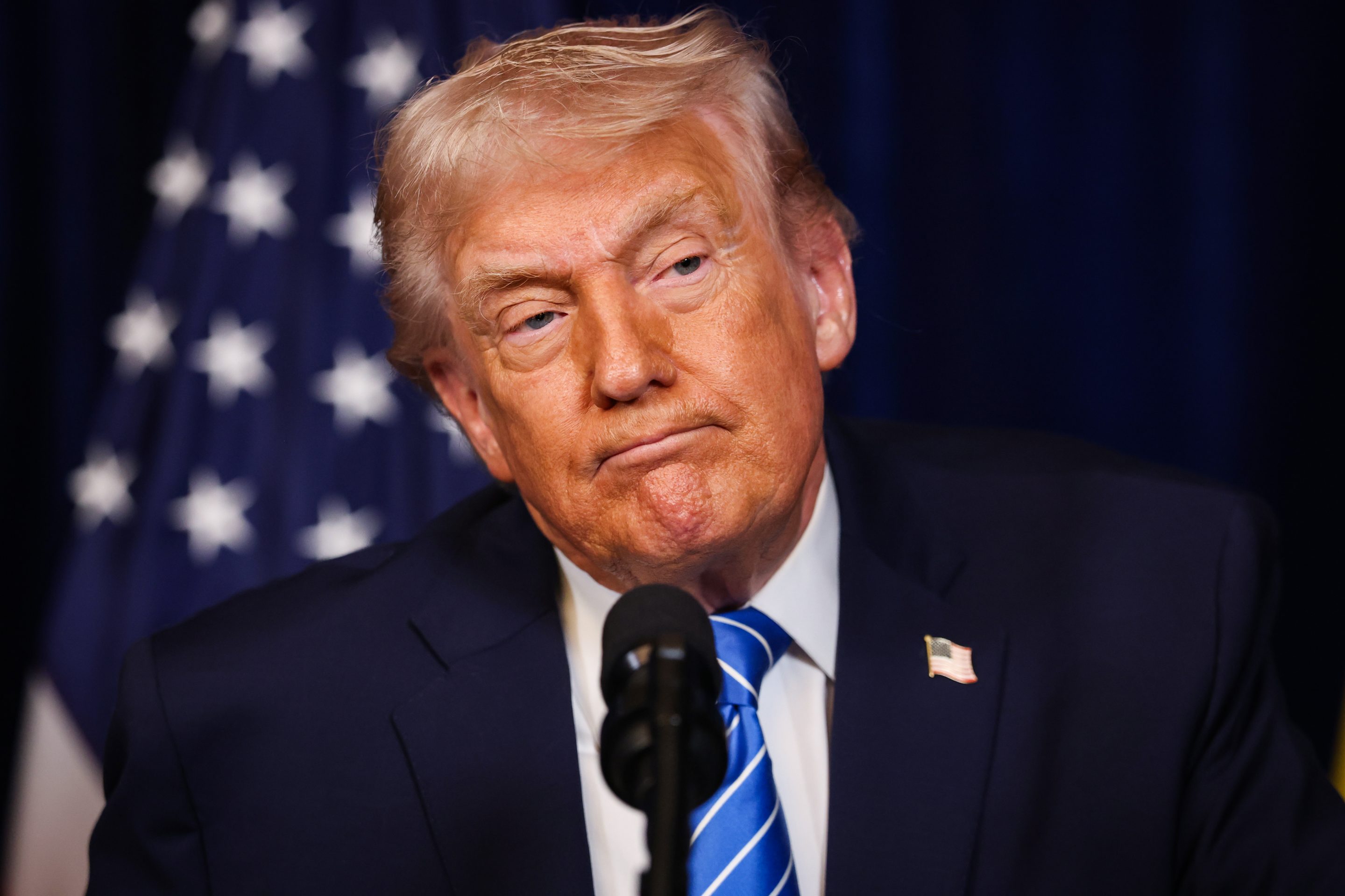 PALM BEACH, FLORIDA - DECEMBER 28: U.S. President Donald Trump listens during a press conference with Ukrainian President Volodymyr Zelensky following their meeting at Trump’s Mar-a-Lago club on December 28, 2025 in Palm Beach, Florida. Trump invited Zelensky to his private club to work on the U.S.-proposed peace plan to end the war in Ukraine, as the conflict approaches four years since the sudden full-scale invasion by Russia on February 24, 2022. (Photo by Joe Raedle/Getty Images)