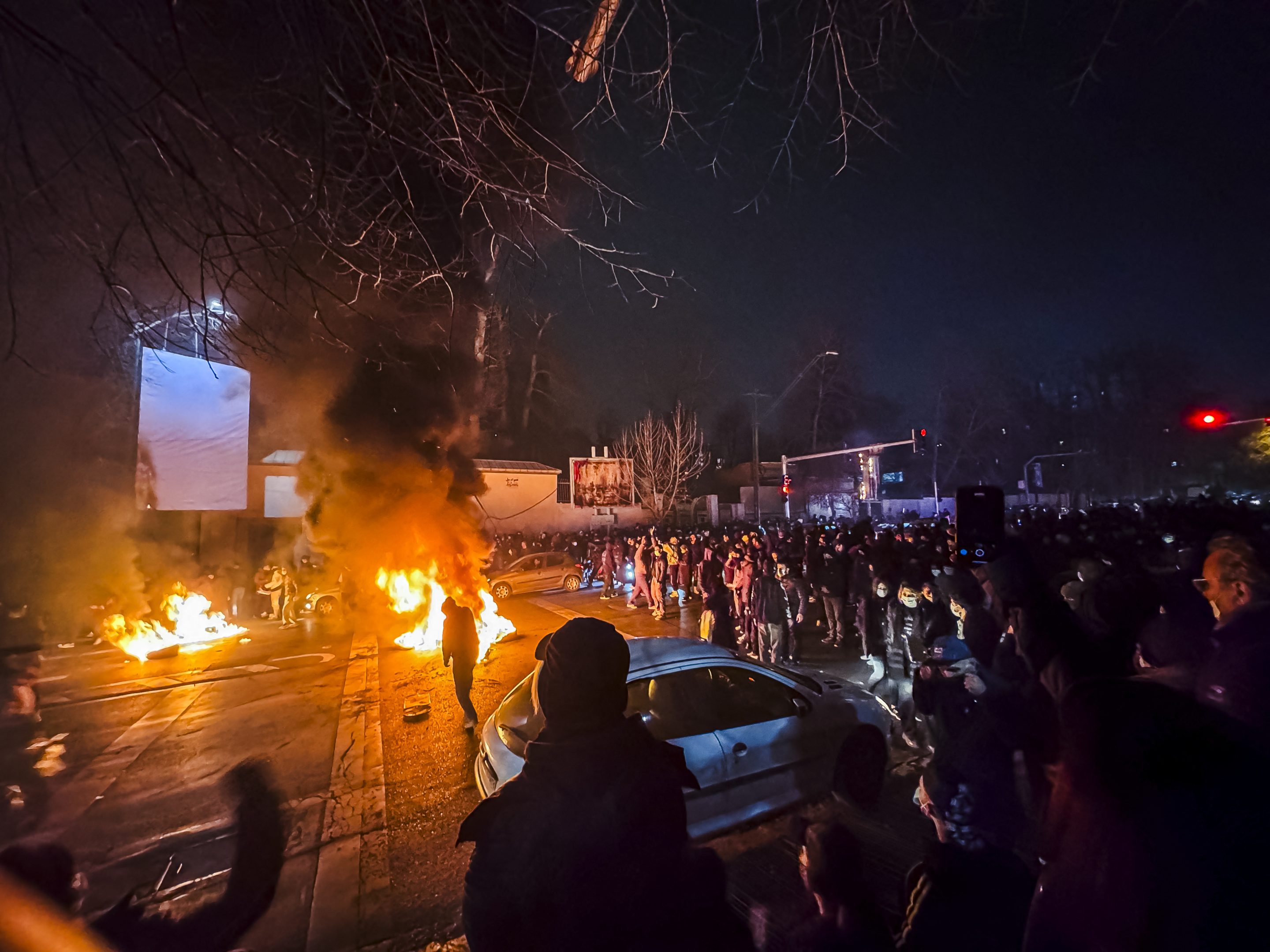 Iranians gather while blocking a street during a protest in Tehran on January 9, 2026.
