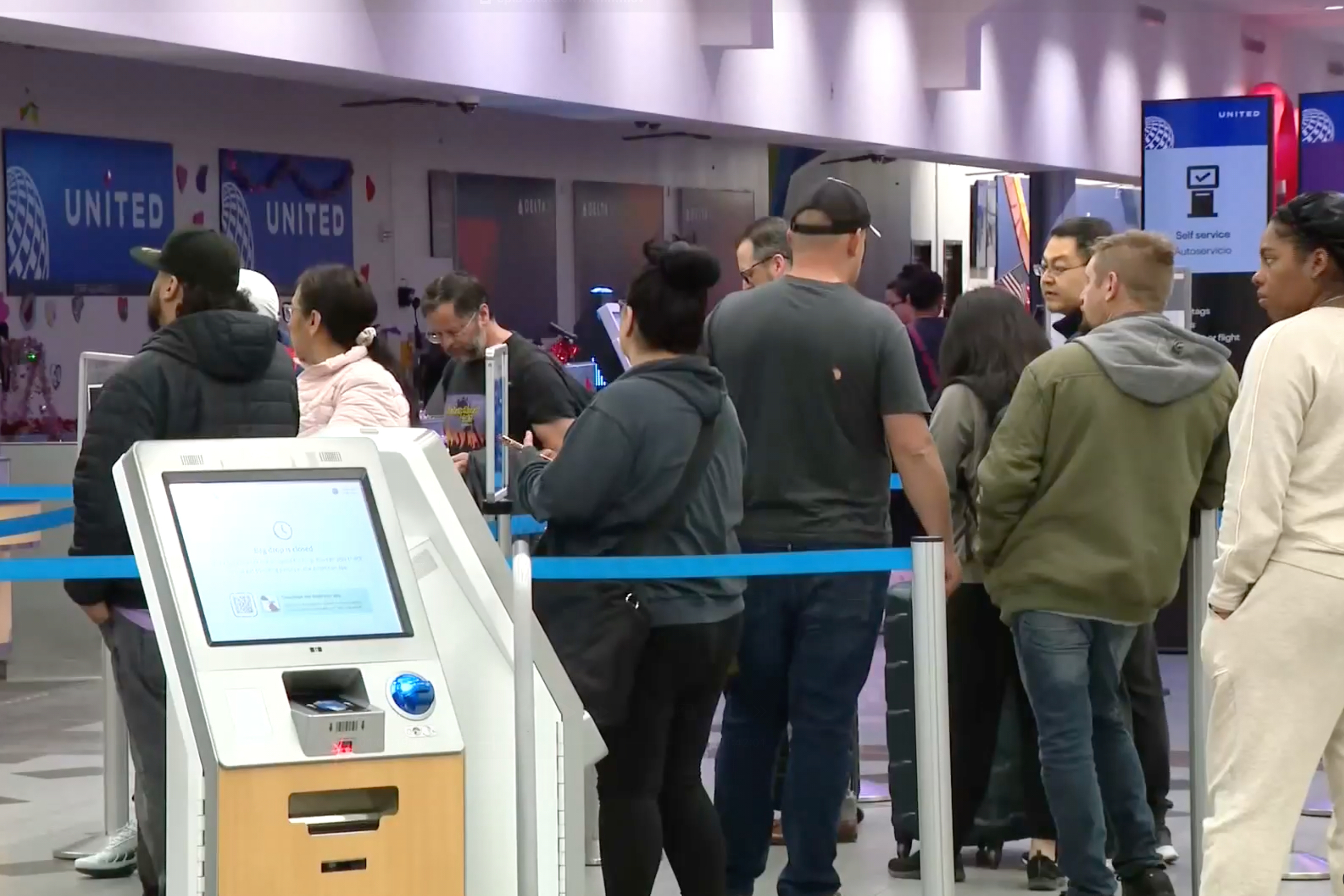 Passengers wait in line at the El Paso International Airport after all flights were grounded on Wednesday, Feb. 11, 2026.