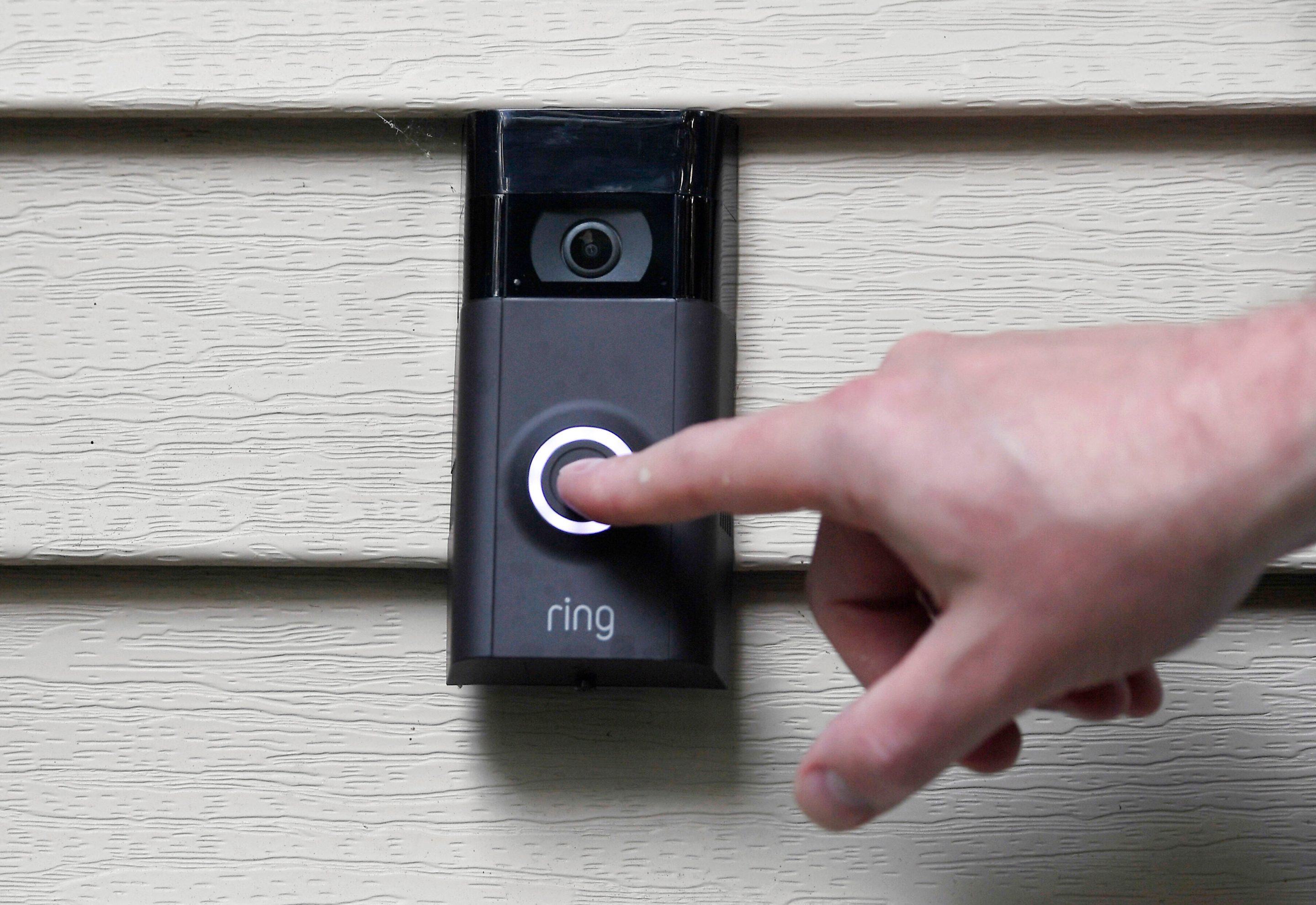 A person pushes the doorbell on their Ring doorbell camera, July 16, 2019, in Wolcott, Conn.